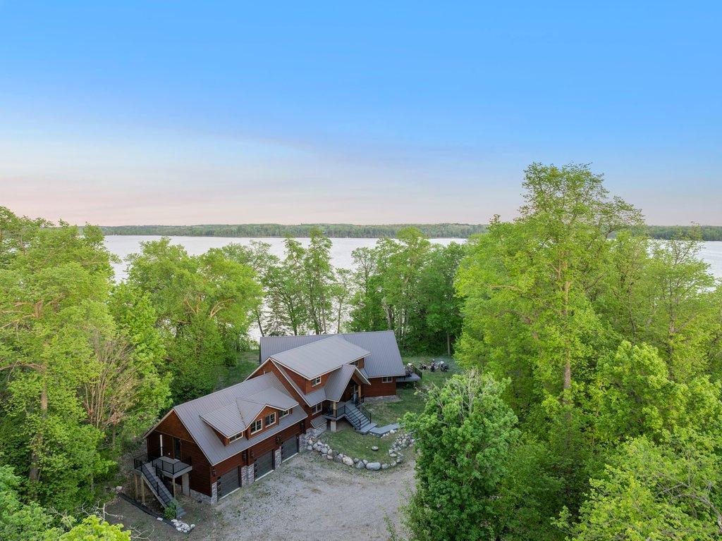 A rare opportunity to own and invest in a turn-key luxury property with a proven record of Short-Term Rental income all within the privacy and northwoods beauty of your own private island on Little Boy Lake. This up north retreat features guest-favorite amenities like a expansive game room with ping pong and pool table, theatre room with projector and surround sound, fireplace, 4+ bedrooms, sandy beach, firepit and plenty of room for snowmobiling and snowshoeing in the winter.

This truly is a year round retreat that both you and your guests will enjoy! Imagine your guests enjoying a winter weekend getaway, freshly fallen snow, driving over the iconic wooden bridge that leads to the property, and enjoying a weekend of memories, nature and luxury amenities. Invest in this unique property today which comes fully furnished and ready to go!