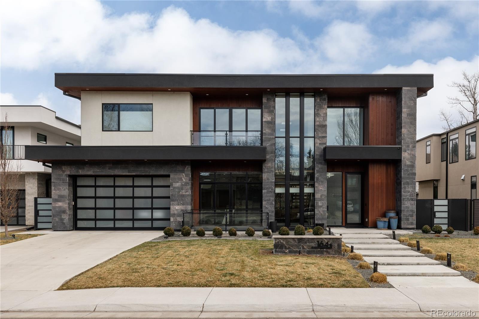 Set in the heart of Hilltop, this custom-built home offers a rare balance of architectural presence, refined materials, and spaces designed for both entertaining and comfortable daily living. A 24-foot entry introduces the home with a sense of scale and light. At the center of the home, a fully automated Pergolux disappearing glass wall transforms the main living area into a seamless indoor–outdoor experience, allowing gatherings to extend effortlessly in every season. The backyard is designed as a private retreat, centered around a 12’ x 28’ heated pool, covered lounge with fireplace, Lynx outdoor kitchen, and grassy lawn. Inside, the kitchen was designed for both serious cooking and everyday connection. Dual islands provide space to prepare, serve, and gather, while a suite of Sub-Zero and Miele appliances—including including dual ovens, convection and steam ovens, built-in coffee station, dual dishwashers, and walk-in pantry. A secondary prep kitchen adds additional appliances, laundry, pet wash, and direct yard access. Upstairs, the primary suite offers a peaceful retreat with a lounge, dual-sided fireplace, beverage bar, and dual custom walk-in closets. The spa-inspired bath features heated floors, steam shower, soaking tub, and Kohler smart toilets. Three additional en-suite bedrooms, a versatile loft, and a professionally outfitted home gym support family life and wellness. The lower level continues the home’s lifestyle experience with a fourth en suite bedroom, tiered theater, and temperature-controlled wine room. Additional amenities include a private elevator, automatic Somfy shades, Control4 integration, whole-home humidifier and filtration, and heated three-car garage with snow-melt driveway. Just minutes from Cherry Creek, Graland Country Day School, Cranmer and Robinson Parks, Pete’s Grocery, High Point Creamery, and Call Your Mother Bagels. Select furnishings may be available for a turnkey experience.