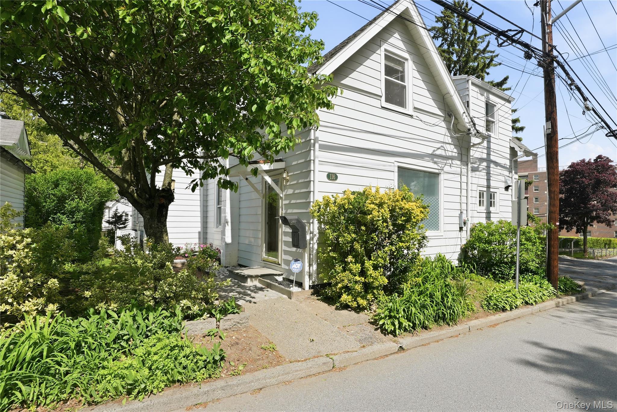 Charming village Colonial is just a short walk to the train, local shops, dining and village amenities.  This inviting home offers classic character with comfortable living spaces, perfect for everyday living.  The main level has a spacious living room, eat-in kitchen and convenient first floor primary bedroom.  Upstairs offers two additional bedrooms with a shared hall bath plus a sitting alcove for office or study space.  A finished lower level of approx. 420 sf provides versatility for a recreation room and 4th bedroom.