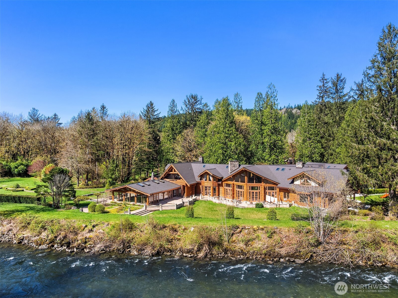 One of a kind custom-built Canadian Red Cedar log home. The estate sits on 36 acres of stunning land with 800 feet of riverfront. Breathtaking panoramas are visible from most of the rooms in the house. The beautiful entryway welcomes you into the impressive interior with travertine floors and high ceilings. The spacious kitchen has a large island and big gathering place. Fantastic Marble and River rock Fireplaces. The primary bedroom features a massive ensuite bathroom and a luxurious dressing room. Indoor pool for all year long use. Gated entrance ensuring privacy perfect for a private multiple home estate or as an event venue, retreat destination. Pre-inspected for your convenience along with clean PNW air and beauty.