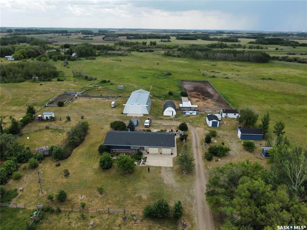 Discover 55.92 acres of opportunity on pavement just minutes from Saskatoon. This well-located property offers an excellent setup for a hobby farm, ideally suited for small livestock such as sheep or goats, with fenced and cross-fenced pasture and watering bowls already in place.The yard site is well-equipped with a massive 40' x 66' Quonset with concrete floor, multiple outbuildings, and established shelters to support a variety of agricultural uses. Functional and versatile, it’s ready to accommodate your operation from day one.The solid 1,617 sq ft bungalow, built in 1973, offers generous living space and has seen key updates including siding, windows, and roof providing added efficiency and curb appeal. Nestled among mature trees with expansive prairie views, it’s a comfortable and inviting place to call home.With pavement right to the driveway and close proximity to city amenities, this property delivers the perfect balance of rural living and convenience. A rare opportunity to own a well-appointed acreage in a highly desirable location.