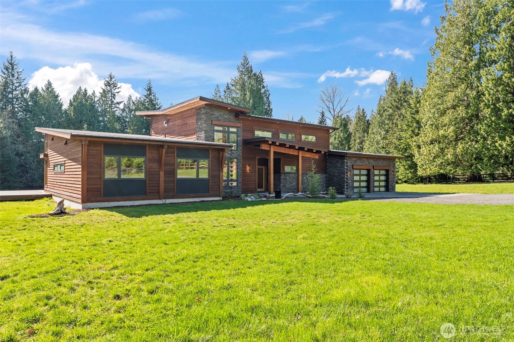 You'll feel at home the moment you walk in. Discover this stunning custom PNW modern contemporary 3 bedroom, 2.5 bath home with main level living designed for comfort and style. Step inside to soaring ceilings, natural wood beam accents, and light-filled open spaces that feel both warm and elevated. The kitchen impresses with a butler's pantry, granite countertops, and premium stainless appliances. Radiant heated floors run throughout the entire home as well as the garage. Outside, unwind on the expansive Trex deck, already plumbed for a hot tub and outdoor kitchen. Enjoy peaceful surroundings just minutes from your own private community beach, the casino, and easy highway access. Set on five peaceful acres, homes like this are a rare find.