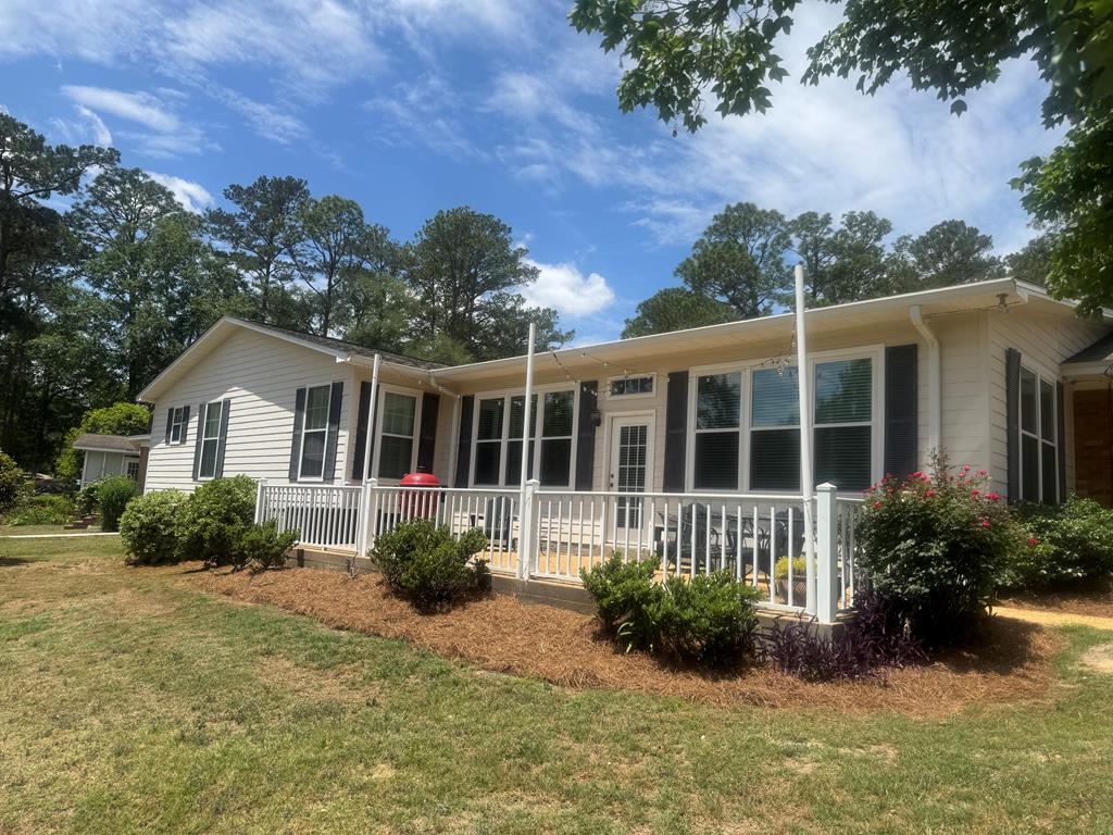 Easy Lake Living in Cairo – 4BR Home with Dock, Patio, Workshop & Beautiful Views  If you've been looking for a place where you can slow down and enjoy life a little more, this home might be just what you need.  From the moment you arrive, you'll notice the spacious yard and welcoming feel of this home. Out back is where it really shines—with a private dock, peaceful lake views, and multiple places to relax and enjoy it all.  Step onto the large patio, perfect for grilling out, hosting friends, or just sitting back and taking in the view.  You'll also enjoy established blueberry bushes that produce well, adding a little extra charm (and fresh berries!) right in your own yard.  Inside, this 4-bedroom, 3-bath home features an open layout that makes everyday living easy. The sunroom offers a bright, comfortable space to enjoy the lake year-round, and the large laundry room adds everyday convenience.  The large master suite gives you plenty of room to relax and unwind, offering a comfortable retreat at the end of the day.  You'll also find open bay storage and a workshop—ideal for hobbies, tools, or extra space.  What you'll love:  4 bedrooms, 3 full baths Open-concept living space Sunroom with beautiful lake views Large master suite with plenty of space Large patio—perfect for grilling, entertaining, or relaxing Private dock and deck right on the water Open bay storage + workshop Large laundry room Established blueberry bushes that produce well Underground pet fence Quiet, family-friendly neighborhood  Whether it's morning coffee on the deck, cookouts on the patio, picking fresh blueberries, or peaceful evenings by the water, this home offers a lifestyle that's hard to beat.  Come take a look—you might not want to leave.