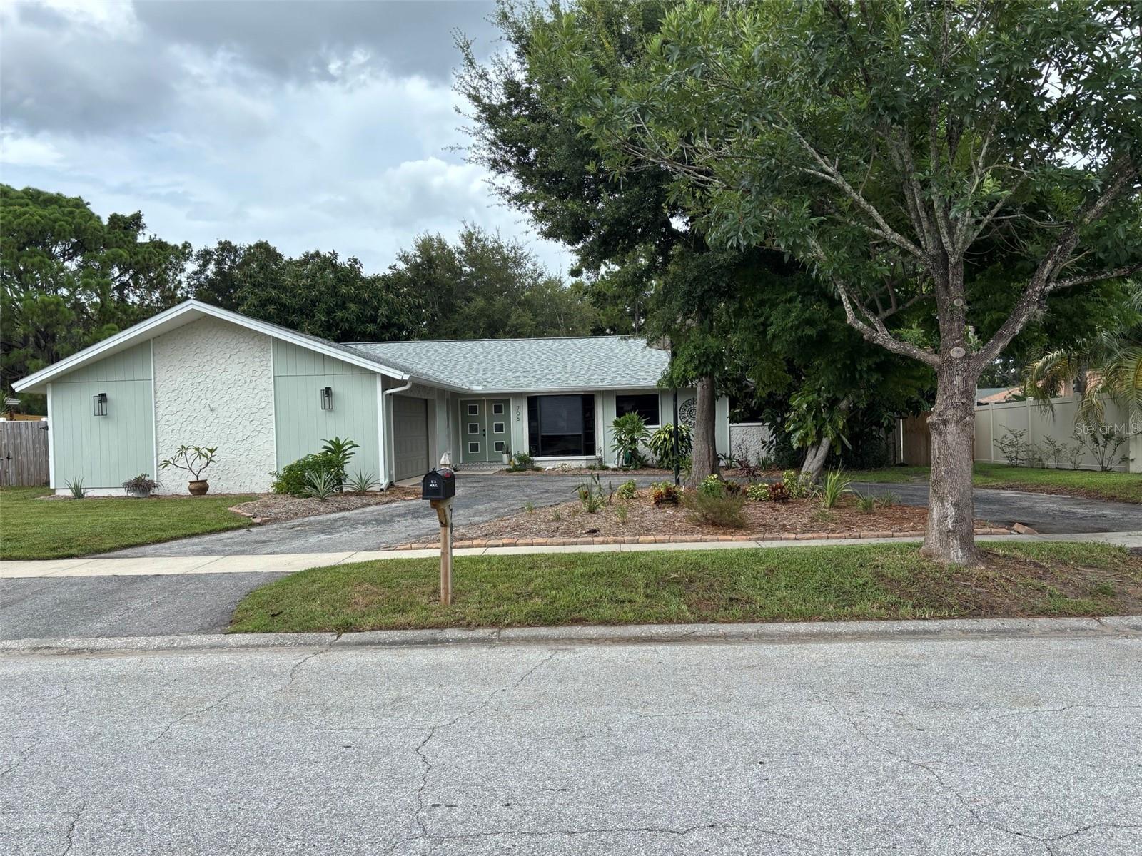 Welcome to 705 Wild Oak Lane and West Lake Village, a premier home in a premier community.  This is not your grandma's dated boxy house.  This home has been recently updated with a new roof, new kitchen with shaker cabinets, quartz counter tops, stainless steel appliances.  Both bathrooms are beautifully updated with solid wood shaker cabinets, quartz counter tops and new tile surrounds.  Wide open main living area with souring ceilings and a bar area, perfect for entertaining.  One of the few floor plans in Westlake Village where you can sit on the couch, see out the front window, watch your big screen tv and look out the HUGE sliding glass doors into your tropically lush, fenced back yard.  No "boxy" feel here.  There is a large screened in patio with your second family room and second dining table, for those awesome winter months, here in Florida.
There is a bar top between the kitchen and great room.  Master Bedroom has more than enough room for a California King sized bed, furniture and even a small couch, if you would like.  Master closet is large enough to get lost.  I would bet this is the largest master closet in the community. Mst bathroom has been tastefully remolded into a spa like feeling.  This home has a nice size, interior, laundry room and last but not least, you have a huge double car garage with a separate area for your work bench and sink.
Westlake village has a huge central park area, with walking trails, pickle ball courts, tennis courts, basketball courts, huge pool, club house, and fun playgrounds for the little ones.  If you hate trees, don't even bother coming to this community.  It has tons of beautiful, mature shade trees.
Bedroom 4 in this home is in the center of the house, with makes it a non-conforming bedroom, but it was used by the last owners for a nursery.  
Listing agent has a vested interest in the property.