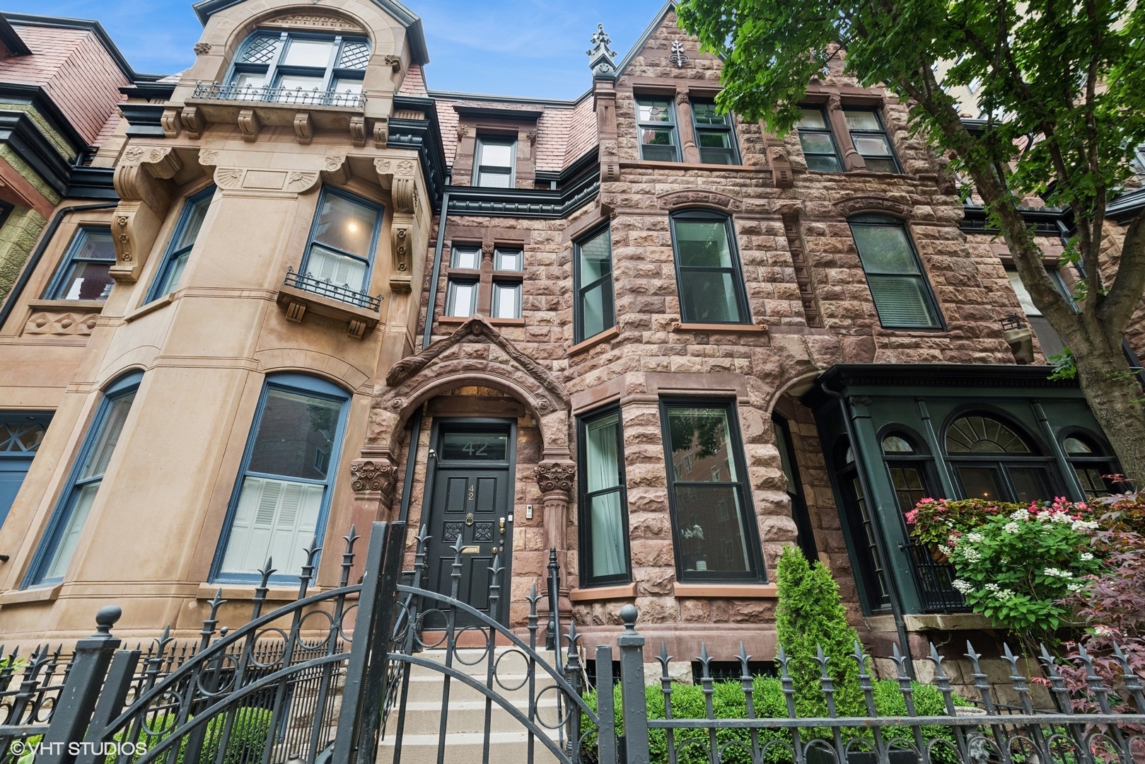 Hidden in Plain Sight - A Gold Coast Gem. Just half a block from Lake Michigan, tucked into the architectural charm of Chicago's iconic Gold Coast, this extraordinary brownstone blends timeless elegance with modern sophistication. Set on a quiet, tree-lined, one-way street between legendary Lake Shore Drive and historic Astor Street, this 5-bedroom, 3 and a half bath residence spans over 4,000 square feet of meticulously curated space.  Inside, soaring 10-foot ceilings, rich dark hardwood floors, and designer finishes create an inviting, elevated ambiance. The main level was thoughtfully designed for entertaining-light-filled and seamlessly flowing. The living room is centered around a striking full-height marble fireplace, while the chef's kitchen stuns with an oversized waterfall island featuring an industrial stainless steel top, beverage drawers, wine cooler, and a stainless farmhouse sink. A full perimeter of marble countertops and custom white cabinetry, open shelving, and top-tier Sub-Zero and Wolf appliances-including double ovens-round out this showpiece kitchen. The second level offers three versatile bedrooms-currently styled as a glamorous custom dressing room, a chic office with fireplace and architectural windows, and a spacious guest retreat. Each room boasts exceptional closet space, offering storage rarely seen in the area. The top level is reserved for the luxurious primary suite. Two walk-in closets, full set of laundry machines, a wood-burning fireplace, and a spa-like en suite bath with soaking tub, oversized rain shower with bench, dual vanities, and recessed mirrored cabinetry create the ultimate sanctuary. Step out to your private treetop terrace with maintenance-free Trex decking-an idyllic perch for morning coffee or evening unwinding.    Additional highlights include top-of-the-line designer lighting throughout, smart home technology with dimmable controls in every room, and a vibrant yet peaceful energy across all four levels. The lower level includes a cozy media lounge with a dry bar and beverage center, a guest suite, a second oversized laundry room with premium machines, utility sink, and custom built-in storage, along with convenient walkout access. A private rear parking pad doubles as a secluded garden escape, with additional valet and garage  parking options just across the street. Located in one of Chicago's most desirable neighborhoods, the Gold Coast offers immediate access to Oak Street Beach, luxury shopping, cultural landmarks, and a celebrated dining scene-Gibsons, Maple & Ash, The Bellevue, Lou Malnati's, Le Colonial, and more. Parks, fitness centers, salons, and neighborhood pubs are all just steps away. This is a rare opportunity to own a piece of Chicago's storied history-where architectural heritage meets elevated urban living.  A private sanctuary, moments from the lake and the vibrancy of the best city.