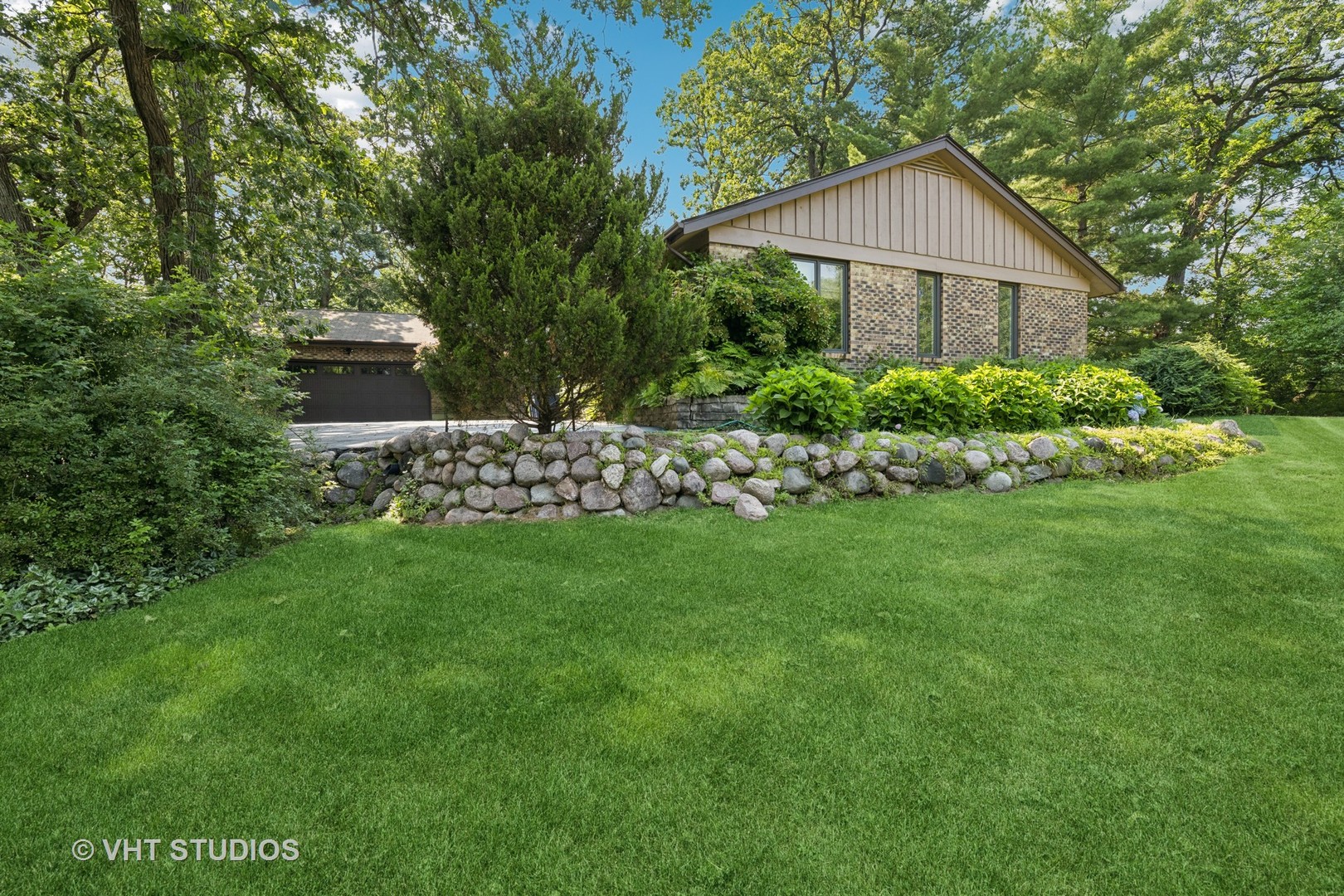 Welcome to this beautifully updated custom ranch in the highly desirable Farmington neighborhood! Nestled on a picturesque 1.21-acre lot with mature trees and tranquil pond views, this meticulously maintained home blends timeless design with thoughtful modern upgrades. Enjoy outdoor living at its finest with a new hardscape path, paver patio, back deck, and a lush garden oasis.    Inside, you'll find hardwood floors throughout most of the main level, complemented by epoxy and vinyl flooring on the lower level. The light-filled sunroom (2009) and stunning studio addition (2000) feature expansive windows that bring the outdoors in. The gourmet kitchen is a showstopper, boasting quartz countertops, high-end appliances, a custom Spanish tile backsplash, and space for casual dining. Entertain in the generous formal dining room or unwind in the cozy family room with a fireplace and walk-out access to the patio.    The main level offers a spacious primary suite with a walk-in closet, additional closet, and private en-suite, plus two more well-sized bedrooms, a bright living room perfect for displaying art, three full bathrooms, and a convenient laundry room.    The finished lower level expands your living space with an extra-large recreation room, space for a bar or media area, an additional flex room ideal for an office or craft room, and abundant storage. Notable recent updates include: 2 new furnaces (2024 & 2025), A/C (2024), garage door (2023), soffits and partial siding repainting (2025), and a whole-house water filtration system (2024). Pella windows throughout ensure comfort and efficiency, and a whole house generator.  Close to Deer Park shopping center, restaurants, entertainment, and award winning schools.  This is a truly special home with nothing left to do but move in and enjoy. A rare find in a coveted location-don't miss it!