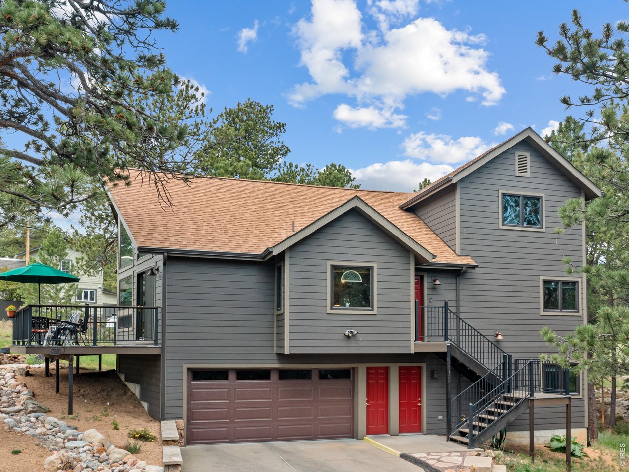 In the Big Horn Dr neighborhood north of downtown Estes Park, 510 Chiquita Ln is tucked into the hills rolling down from Lumpy Ridge & settled among the vintage homes of this classic mountain locale. With its ship's-prow wall of south-facing windows & its lofty great room, this beautiful home offers breathtaking Longs Peak views and the perfect location for enjoying the mountain scenery for a pure Colorado experience. The large lot has mature ponderosa pines & the property provides plenty of room to relax & enjoy the fresh alpine air & natural surroundings. This ideal site allows you to enjoy the quiet of the mountains & the convenience of town living. Leave your car at home for a short walk to downtown Estes, giving you easy access to shops, breweries, restaurants, & galleries. Just west of the Stanley Hotel, & north of downtown, you can walk to year-round events from concerts at the Stanley to festivals in Bond Park. The neighborhood has great loops of quiet streets for dog walking! W/ its moss-rock fireplace, the great room allows you to stretch out & relax. The dining room has room for a crowd & the kitchen is made for cooking. From snuggling by the fireplace to hosting gatherings on the big deck, nature's beauty is your constant companion. The primary BR is on the main floor. The upstairs level has an office/loft & 2nd BR. There's a spacious BR/family room downstairs for exercise, music, yoga, or crafting. The over-sized 2 Car Garage offers room for all your vehicles/toys/projects.The home has new siding, decking, windows, roof, water heater & more! This Estes haven will lift your soul & give you that feeling of expansiveness that mountain living entails, both humbling & inspiring. Enjoy the tranquility & spectacular views in this meticulously maintained home in one of Estes Park's nicest neighborhoods. Experience mountain charm close to downtown Estes & Rocky Mountain National Park. Come home to Chiquita & find peace in mountain moments.