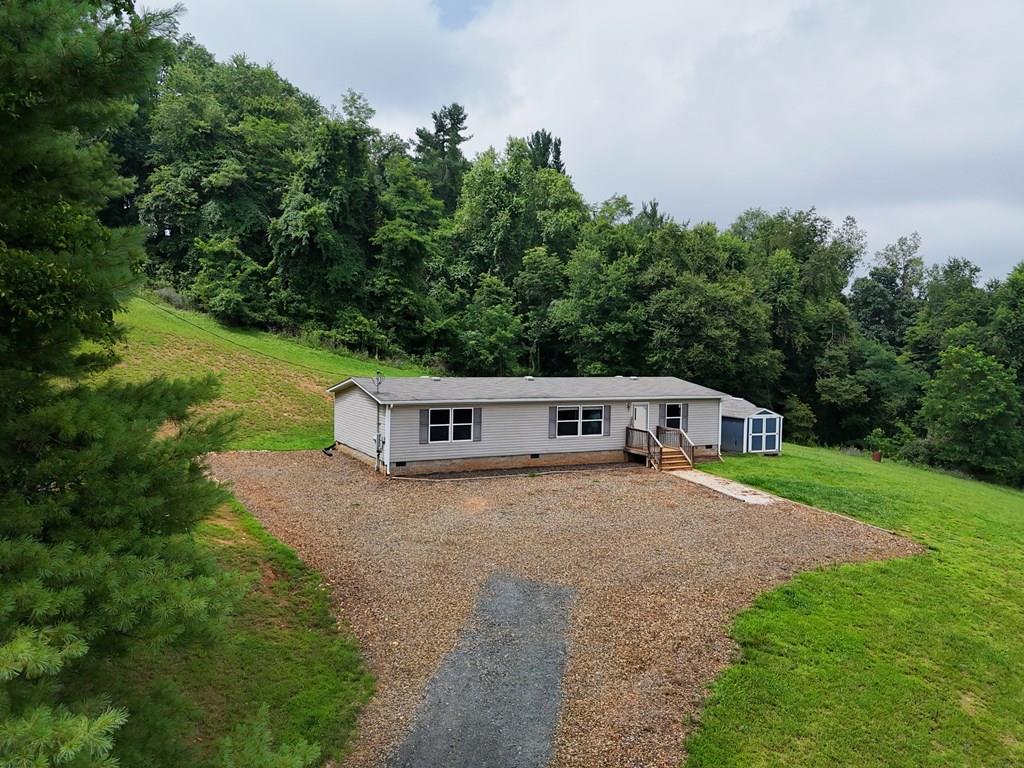 Lovely three-bedroom, two-bath, one-level home situated on 3.59 very private acres, just 15 minutes from downtown Floyd. Enjoy a spacious living room, open kitchen, and dining area—perfect for comfortable everyday living. The large primary bedroom features a walk-in closet and an en-suite bath. Outbuildings, carport, and chicken coop all convey, offering great flexibility for storage, hobbies, or small homesteading. Call today to schedule your private showing!