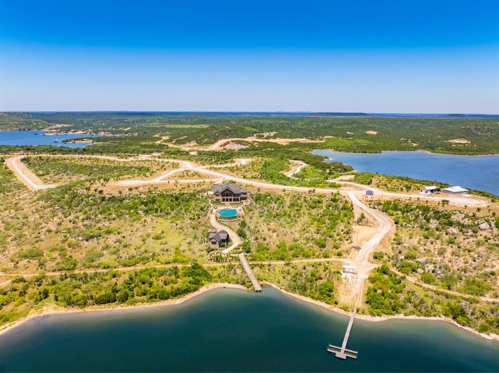 Discover an incredible opportunity to build your dream lake retreat in Clearwater Point, Possum Kingdom Lake's newest premier waterfront community. Spanning just over 2 acres, this is one of the largest homesites in the entire development, offering endless possibilities for creating the ultimate family compound or luxury getaway.Approved by the developer for up to four separate structures, this property provides the flexibility to design a main residence with guest homes, a Sunday house retreat, or additional space for family and friends. Few properties at Possum Kingdom Lake offer this level of versatility.Ideally situated just steps from the community boat ramp, clubhouse, and resort-style pool, you'll enjoy easy access to everything Clearwater Point has to offer while taking in unparalleled lake views. Large homesites with this much flexibility are becoming increasingly rare at Possum Kingdom Lake. Bring your builder and turn your vision into reality in one of the lake's most exciting new communities.