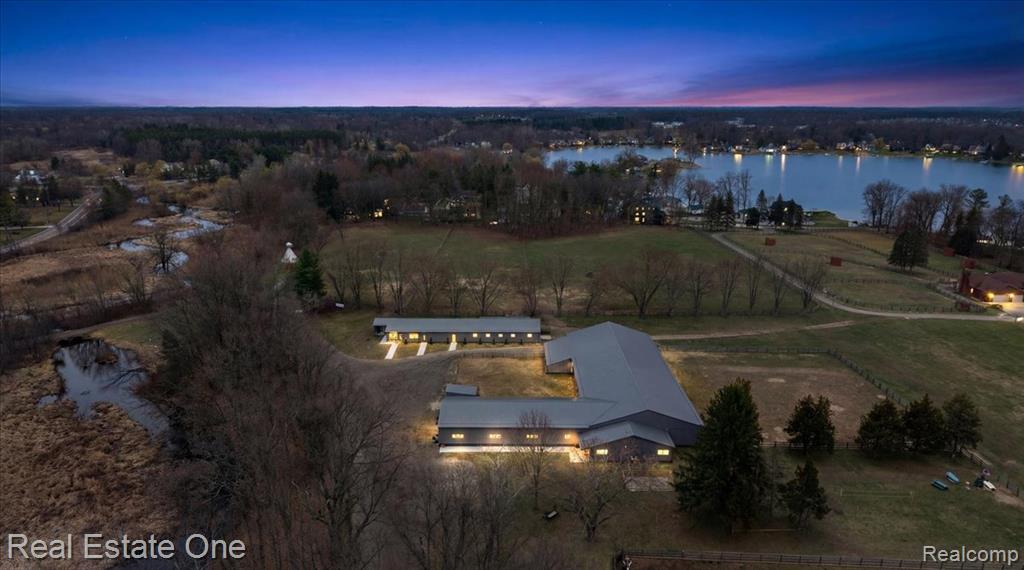 An extraordinary equestrian estate set in a breathtaking natural landscape. Cross the Huron River to reach your own private retreat, where over $1 million in upgrades have been completed within the last five years.The property is thoughtfully designed for both function and comfort, featuring a 60' x 150' indoor riding arena and a total of 22 spacious 10' x 12' stalls. The barn includes a well-appointed observation room with a full bath, along with an office, tack room, and dedicated kitchen area.Additional highlights include a custom greenhouse, a poultry barn, and raised garden beds, offering endless opportunities for hobby farming or sustainable living. Outdoors, you'll find a large riding arena, picturesque trails, and three expansive pastures with all new fencing.The main residence overlooks the river, providing peaceful views and direct access for kayaking or canoeing. A beautifully finished 1,300 square foot guest house includes a full kitchen, bath, and large screened porch. All with serene views of the surrounding pastures and river. Make sure to watch the video tour attached to the listing. Ideally located near shopping and dining, this property offers the rare combination of convenience and complete seclusion—an exceptional place to call home. Please do not enter the property without a confirmed appointment.