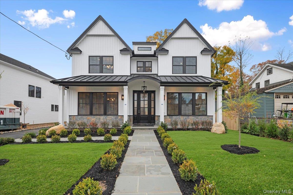 Welcome to this stunning new construction nestled in the heart of Port Washington, just a short walk to the train and town. This architectural gem was custom designed and crafted with unparalleled quality, showcasing attention to detail throughout the entire house.As you enter, you'll be greeted by an impressive double-height entry foyer, a formal living room and a great room with a fireplace both connected by a casual sitting room. Beautiful archway designs show timeless elegance. This state-of-the-art kitchen features top-of-the-line appliances, custom soft-closing cabinetry, a large center island, and an adjoining breakfast area, offering a chef's culinary dream. A glamorous wet bar elevates the formal dining room, perfectly created for entertaining. The upper level features the master suite,  including a walk-in closet and a luxurious spa like bath with a freestanding tub.  Additionally, two bedrooms share a bathroom and another suite. The finished basement provides additional living and recreation area with a custom-built theater, a bedroom, gym, full bathroom, laundry room and an outside entrance. This home is drenched in sunlight, and sits on a flat property. Enjoy close proximity to the town, restaurants, parks, golf, beaches, and LIRR.