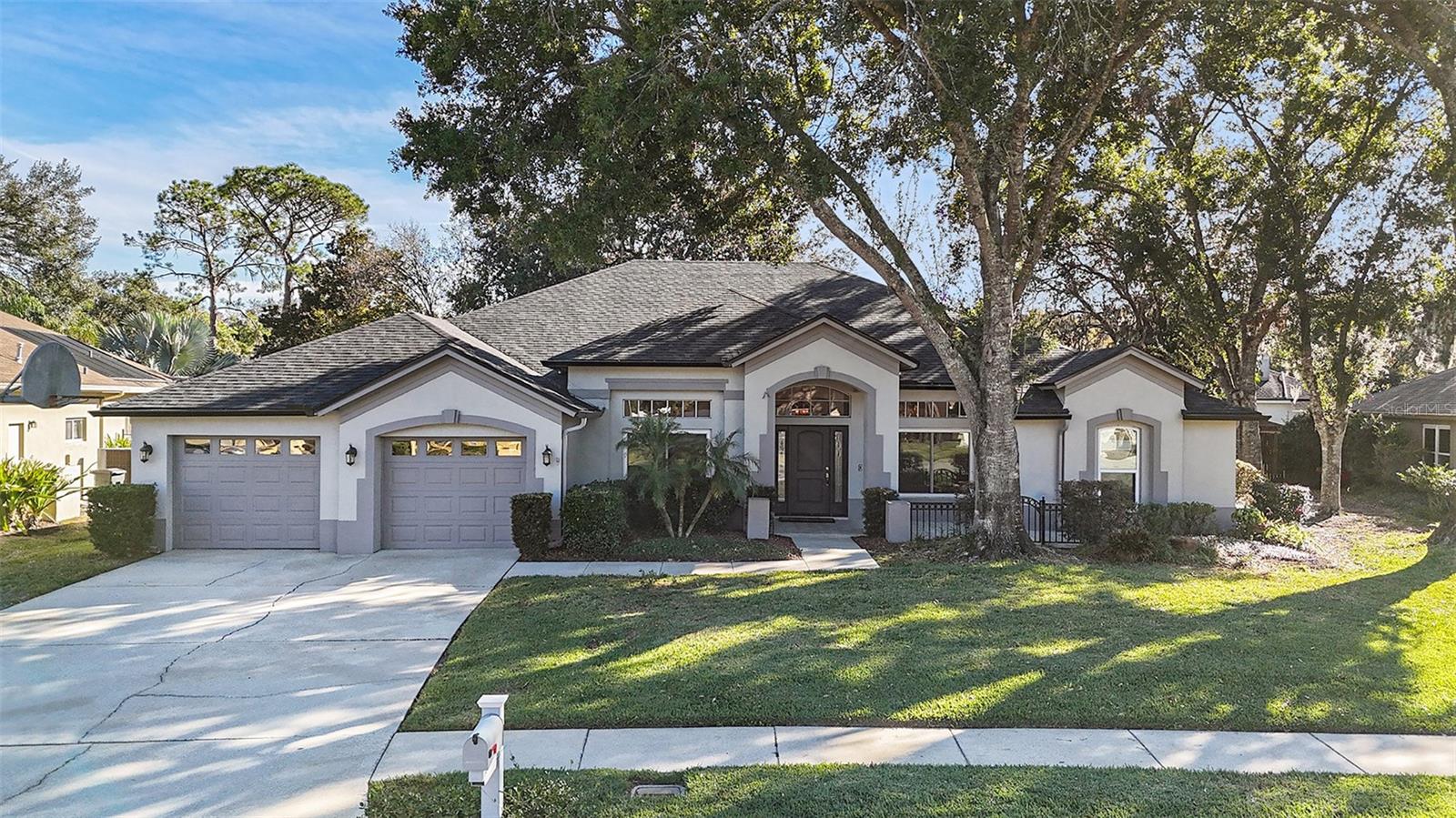 Discover peaceful living in this beautifully updated 4-bedroom, 3-bath pool home located in the highly sought-after Tampa Palms community. From the moment you step inside, it is designed with sophistication and comfort in mind. This exquisite home welcomes you with an expansive open floor plan, where you feel the warm, welcoming living room, dining room, and spacious family room with a two-sided fireplace into the kitchen area. At the heart of the home is the gourmet kitchen, perfect for everyday living and entertaining. Enjoy custom soft-close cabinetry, Cambria quartz countertops, two bar fridges, built-in double ovens with warming drawer, convection oven, microwave, dishwasher, garbage disposal, and a hot water dispenser. Retreat to the master suite, a true haven of comfort and space. This vast space features beautiful tray ceilings that add depth, along with two generous walk-in closets, one of which is thoughtfully enhanced with a few custom cedar drawers. The suite flows seamlessly into a beautifully updated master bath. Enjoy the split bedroom floor plan with the additional 3 bedrooms designed for comfort and a quiet retreat. A you are finished with the beautiful and seamless layout, step outside to your tranquil backyard oasis featuring a sparkling pool, a putting green, and a serene space perfect for relaxation or gathering friends. The roof is brand new as of 9/2025. Taxes are with a Veterans discount.