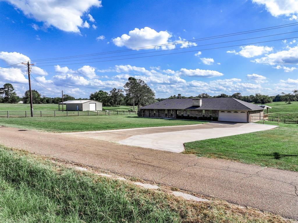 Located near Lake Bob Sandlin and Lake Monticello is where you'll find this updated 3 bedroom, 2 bath home with a separate office, 2 dining areas, and a workshop!. On 1.66 acres, the 30x40 workshop comes with electricity, plumbing, 2 roll-up doors, a 20x30 lean-to and a walk-thru door. Inside the home, you'll notice the vaulted ceilings and wood-burning fireplace in the spacious living area. Enjoy cooking in the kitchen that includes custom cabinetry, granite countertops, stone backsplash, island with breakfast bar, stainless steel appliances, and large walk-in pantry. Two dining areas, the large living area and the extensive covered back porch provide a great space for entertaining. The primary ensuite bedroom comes with a vanity area, double sinks, granite countertops, large walk-in tiled shower, and a oversized walk-in closet. A full bathroom is shared by the two guest bedrooms and office. Walk-in closets are found in both guest rooms with one bedroom including a built-in desk. A new roof was put on the home in 2025. Relax on the back porch with the view of a large pond and wide open pasture to enjoy the peacefulness of country living.