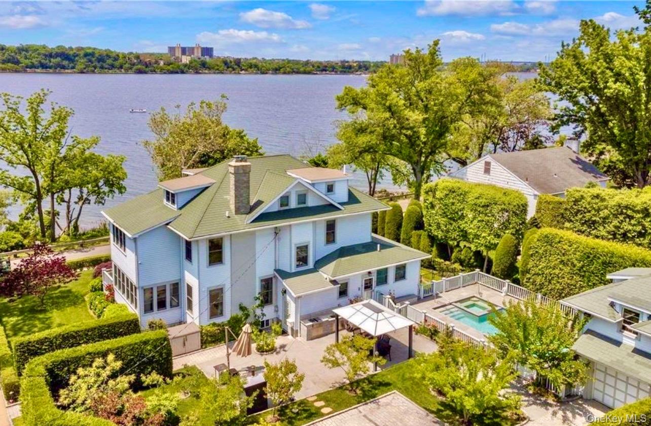 NEW TO MARKET! DOUGLAS MANOR WATERFRONT MASTERPIECE WITH POOL. Enjoy panoramic water and sunset views from many rooms throughout this residence. A total of 5 bedrooms, open layout double living room, high ceilings, FPLC, access to a private outdoor porch, elegant open dining room, custom eat-in-kitchen with creative millwork throughout, easy access to private yard and pool. A tranquil primary en suite with a private balcony and stunning water views, walk-in closets and a spa-like bathroom. An open lower level with FPLC, garage, private driveway and lush landscaping.