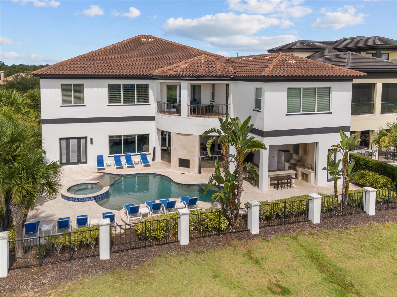 Ideally located in the award-winning REUNION RESORT and overlooking the 6th hole of the Jack Nicklaus designed Tradition golf course, presenting this spectacular FULLY FURNISHED custom ESTATE HOME boasting a lifestyle of pure LUXURY! Upon arrival, an impressive double-heighted ceiling entryway opens to the foyer and huge living/great room areas with large sliding doors framing PICTURE PERFECT VIEWS. Designed to accommodate large gatherings, experience the true Florida lifestyle, seamlessly blending the indoor & outdoor lounge and dining areas featuring automatic retractable screens as well as multiple entertainment spaces. Perfect for both family & guest entertaining and/or to use as a REVENUE/INCOME GENERATING INVESTMENT property (with the added available opportunity to transfer future bookings!). At the heart of the residence is a magnificent CUSTOM high gloss gourmet kitchen with quartz countertops, stainless steel appliances, oversize central island and hidden spacious walk-in pantry. Design features are a bound and include contemporary flooring, MODERN BESPOKE CABINETRY, tray ceilings and DESIGNER fittings. Enjoy the vast array of AMENITIES this residence has to offer including an ARCADE room jam packed with a wide variety of electronic games, a CASINO themed room decked out with cutting edge digital slot machines, a unique open-concept living entertainment space with secondary kitchen/bar area and countertop seating, lounge area as well as a luxury HOME THEATER (with seating for 12). Additional features include a fully equipped fitness GYM and a private SPA with sauna & steam shower. For your added convenience, there is also a residential elevator!  Each of the 11 luxurious bedrooms have ensuite bathrooms and are well appointed in size with two PROFESSIONALLY THEMED MASTERPIECES sure to impress – the Jurassic Park room sleeps 5 and showcases a life-size dinosaur head and jeep vehicle-bed whilst the Steamboat Willie Mickey Mouse room has bunkbeds which sleep 8. The PANORAMIC FAIRWAY VIEWS can be especially appreciated from the upper balcony area as well as from under the covered lanai and open patio areas with heated sparkling POOL featuring a beach entry point, spa and fountain. Make the most of the outdoor full BBQ kitchen with plentiful dining space, casual countertop seating together with an inviting lounge area with two-sided fireplace watching early morning sunrises and late evening sunsets! An ACTIVE TRANSFERRABLE MEMBERSHIP grants access to the many amenities of the Reunion Resort with its three world class golf courses (designed by Arnold Palmer, Tom Watson and Jack Nicklaus), a golf academy, Clubhouse at The Bear’s Den, six onsite restaurants, twelve community swimming pools, a multimillion-dollar water park, six Har-True tennis courts, pickleball, bocce ball, volleyball, crazy golf, a playground, and full-service salon & spa. Reunion is only a couple of miles away from Walt Disney World Resort, Seaworld and Universal Studios. VIRTUAL TOUR, VIDEO and FLOORPLAN are available. Book your private showing today and make this dream home your reality!