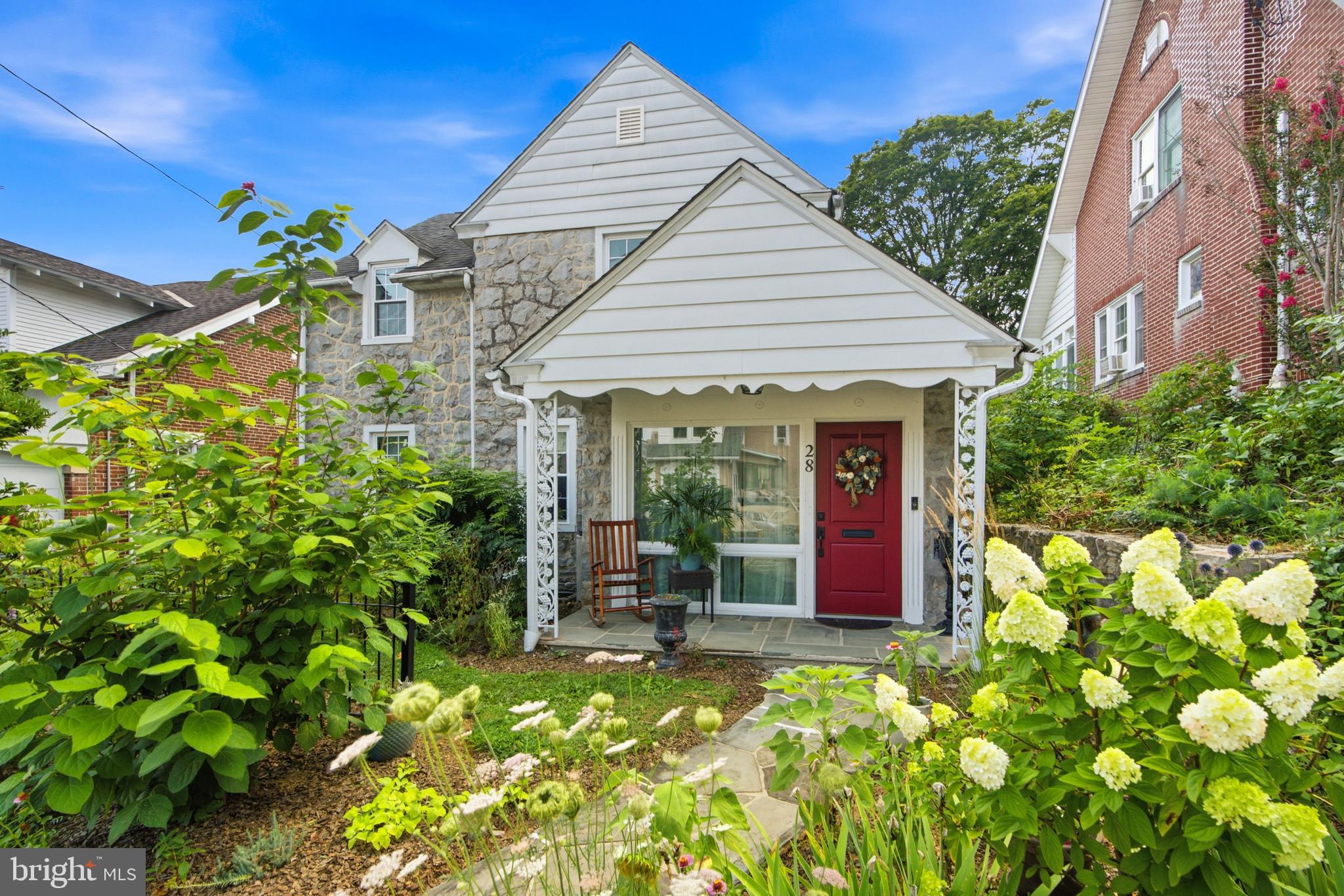 Classic Boyertown Stone Colonial with Gardens, Greenhouse, Local History & Rare Turnkey-Style Inclusions. Welcome to 28 W 2nd Street, a charming detached stone Colonial in Boyertown Borough offering 3 bedrooms, 1 full bath, 2 half baths, and approximately 1,882 square feet of above-grade living space. This classic 1910 home blends old-home character, thoughtful seller-disclosed improvements, established gardens, and a rare turnkey-style opportunity with many furnishings and property items included.The main floor features wood floors, a spacious living room with pellet stove insert, formal dining room, updated kitchen, convenient powder room, den with built-ins, and a rear mudroom/entry area with attractive patterned tile flooring. The kitchen offers stylish cabinetry, attractive countertops, stainless appliances, induction cooking, farmhouse-style sink, and a warm, updated feel.Upstairs are three bedrooms, including a spacious primary bedroom with hardwood flooring and a wall-mounted mini-split, plus a full bath and an additional half bath. The home also offers public water and sewer, oil hot-water radiator/baseboard heat, and three second-floor wall-mounted mini-split units with heat, A/C, dehumidifier, and fan functions. Additional features include deep window sills, classic trim, and an unfinished basement with walkout stairs.The exterior offers a charming garden-style setting with mature plantings, flowering perennials, established cutting gardens, greenhouse, porch areas, and included lawn/garden equipment. The gardens are designed to provide seasonal cutting flowers, adding warmth, color, and lifestyle appeal throughout the year.Seller-disclosed improvements include kitchen and dining renovations, replacement of most windows, mini-splits, pellet stove, radon remediation system, security lighting, attic fan/vents, front fence, greenhouse, updated toilets, hard-wired smoke/carbon monoxide detectors, electrical outlet improvements, 2021 appliances, and more. Adding to its Boyertown charm, public record history indicates the home was once owned by Paul R. and Erminie F. Hafer, founders of the Boyertown Museum of Historic Vehicles.Many furnishings, appliances, greenhouse, lawn/garden equipment, porch furniture, beds, dining furniture, living room furniture, TVs, washer/dryer, and other items are included as detailed in the Property Inclusions Addendum. See Property Inclusions and Exclusions Addenda for complete details. Conveniently located close to Boyertown amenities, shopping, dining, parks, schools, and major routes.