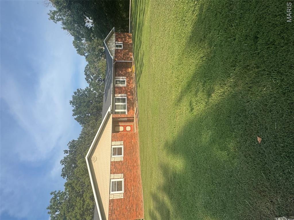 Large brick home located right outside city limits. Back of the home is connected to the hole #1 at the Bloomfield country club. Four bedrooms and 2 1/2 baths. Walk-out basement. Two fireplaces the one upstairs is gas log and the one in basement is wood burning. New furnace (2023),new windows(2019), new roof(2019),new water heater(2021) and new deck(2019). New  wood flooring in family room, kitchen, hallway, bathroom, and bedroom. Home has walk-in jacuzzi tub.  Home has 1.57 acres (m/L). Call to see this home to make it your own
