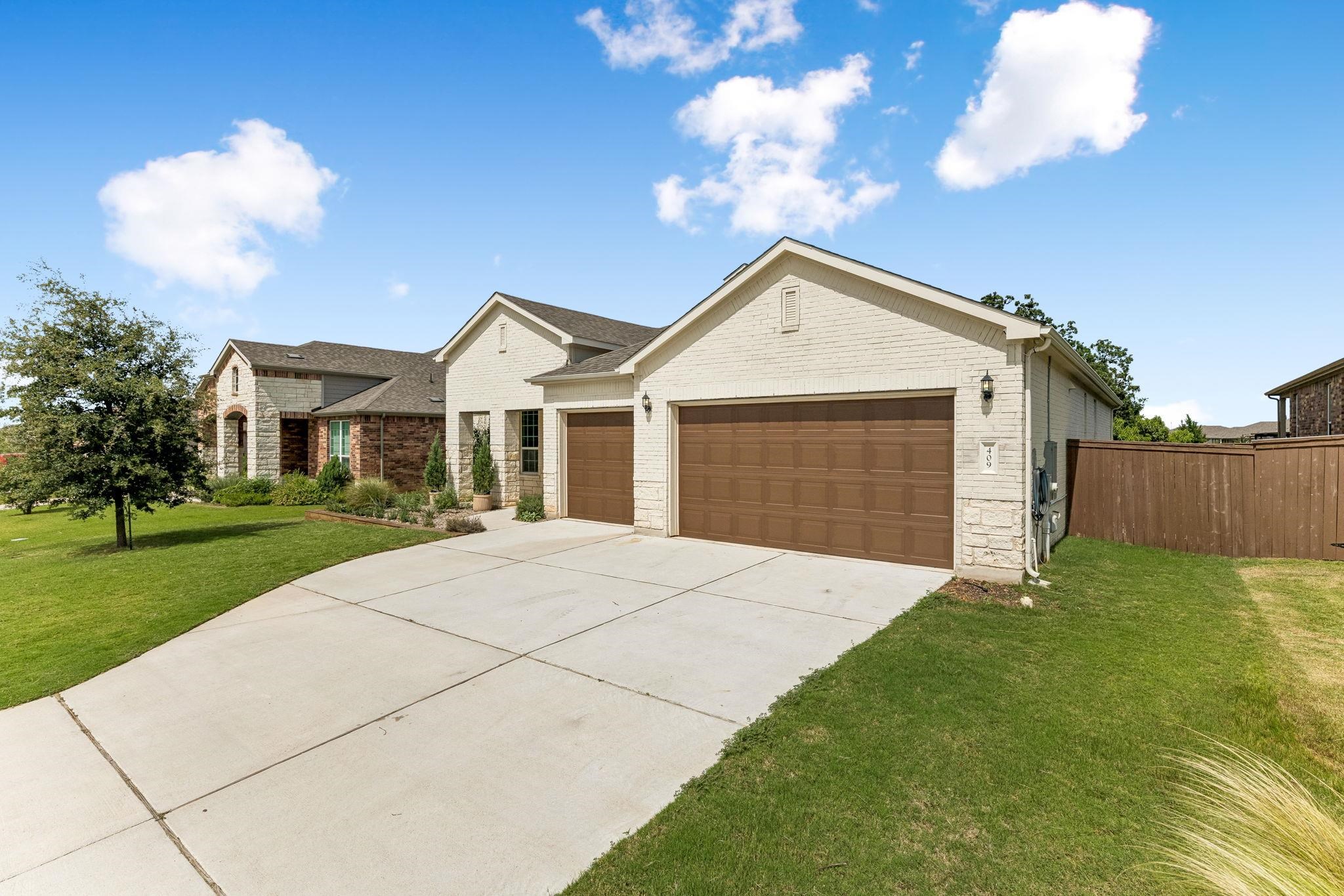 Refined Hill Country living in the highly sought-after Gregg Ranch community. Built in 2021, this impeccably maintained 3-bedroom, 2.5-bath home offers 2,211 square feet, a dedicated office, and an oversized 3-car garage. The open-concept floor plan features a gourmet kitchen with quartz countertops, a large island, stainless steel appliances, and both the refrigerator and wine fridge convey. Designed for modern living, the home includes fresh paint, new carpet, recessed lighting, whole-home surge protection, EV-ready 50-amp service, dedicated garage circuits, Ethernet wiring, 5.1 surround sound pre-wire, and an overhead garage storage loft. Enjoy the covered patio overlooking a beautifully landscaped backyard with a 10-zone irrigation system, raised steel garden beds, drip irrigation, custom trellis, and producing peach and fig trees. Gregg Ranch offers resort-style amenities, including a pool, pickleball and sport courts, parks, and 5.5 miles of hiking and biking trails, all just minutes from Lake Marble Falls, Lake LBJ, historic downtown Marble Falls, Hwy 281, and Hwy 71. Home is easy to view!