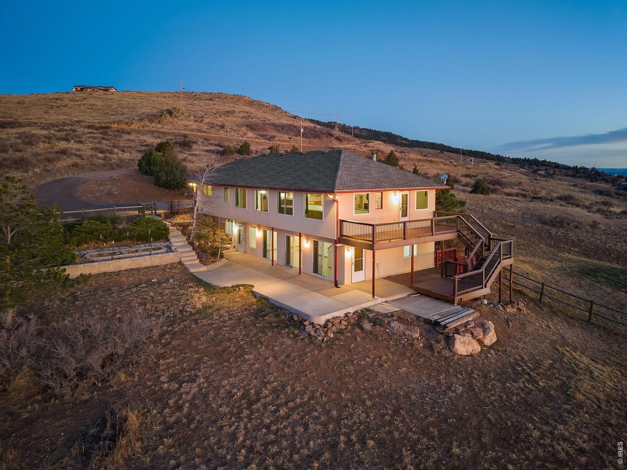 Perched on 32 low-maintenance acres within a gated community, this exceptional Loveland property offers the perfect blend of privacy, natural beauty, and convenience. Surrounded by sweeping panoramic views, abundant wildlife, and unforgettable sunrises and sunsets, this is Colorado living at its finest-all just minutes from Horsetooth Reservoir, Downtown Loveland, and Fort Collins.This raised ranch home features 5 bedrooms, 3 bathrooms, and over 3,400 square feet of thoughtfully designed living space. Freshly updated with brand new interior paint and carpet, the home is move-in ready while still offering opportunities to make it your own. The main level offers a functional and inviting layout with a dedicated office, one bedroom, and a full bathroom-ideal for guests or flexible living. The cozy living room is anchored by a wood-burning fireplace and flows seamlessly into the kitchen and outdoor living spaces. The open kitchen layout boasts granite counters and SS appliances. The walkout basement serves as a private retreat, featuring the primary suite with ensuite bath, three additional bedrooms, another full bathroom, laundry, and a spacious secondary living area-perfect for relaxing, entertaining, or multigenerational living. Designed to maximize indoor-outdoor living, the property boasts multiple patios and an impressive three-tier deck-perfect for entertaining or simply soaking in the breathtaking surroundings. An oversized 3-car garage provides ample storage, while dual hot water systems, including a solar hot water heater, add efficiency and sustainability. Enjoy the best of both worlds-peaceful mountain-style living with easy access to parks, trails, breweries, and restaurants. With Loveland known as the gateway to Rocky Mountain National Park and both Loveland and Fort Collins consistently ranked among the best places to live in America, this property is more than just a home-it's a lifestyle.