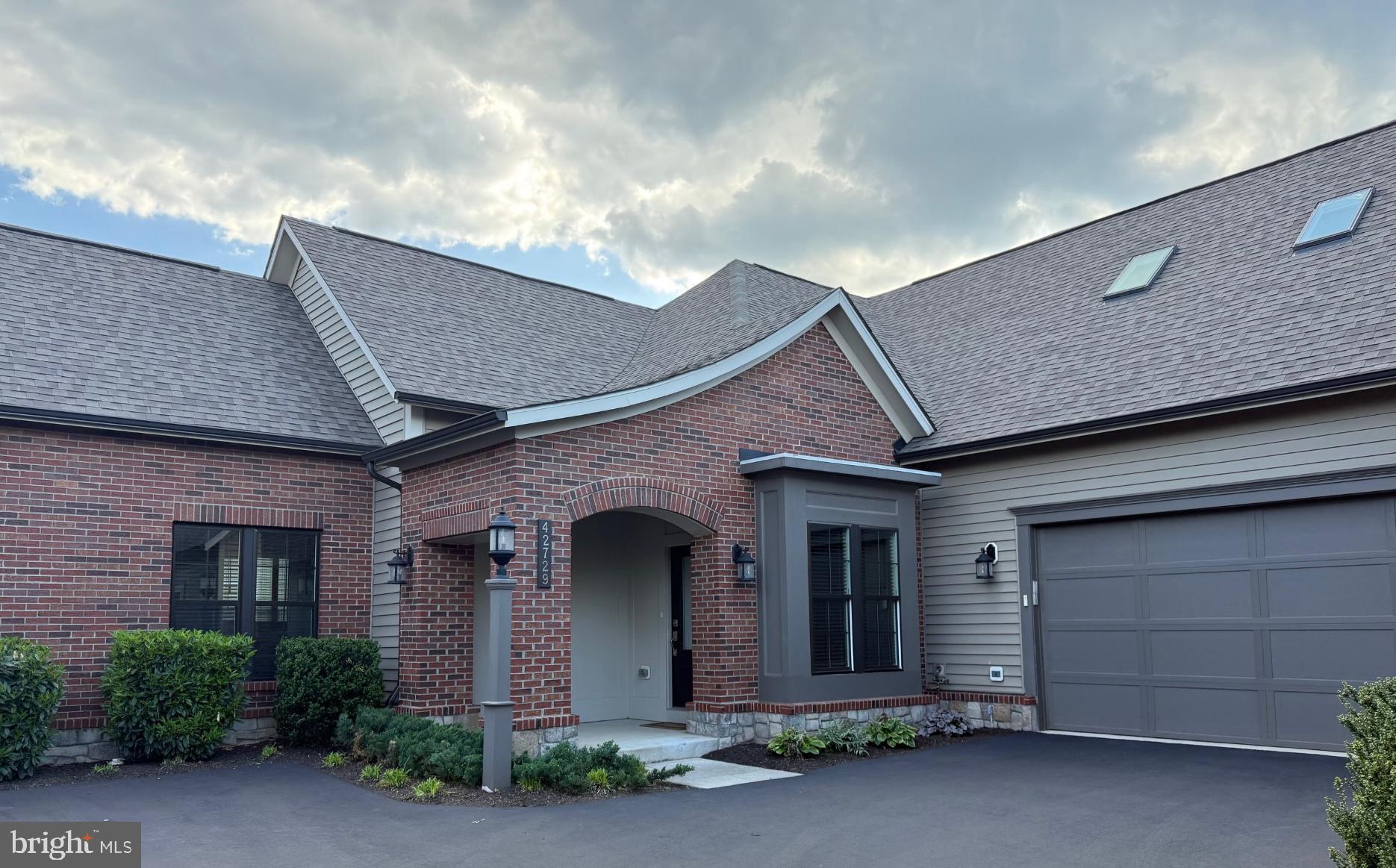 Live Your Best Life: Luxury Active Adult Living! Welcome to the highly sought-after 55+ community of Birchwood at Brambleton, where lifestyle and comfort come together seamlessly. This GORGEOUS courtyard home offers premium upgrades and easy one-level living.  The spacious main level features a luxurious primary bedroom, hardwood floors, a spa-inspired primary bath with a frameless glass shower, designer tile, grab bars, bench seating, and a large custom walk-in closet.  Also on the main level: a second bedroom and full bathroom, a den (which could also serve as a formal dining room), a laundry room, a spectacular chef's kitchen, a breakfast room, and a screened porch perfect for morning coffee or evening breezes. The second level offers a second family room ( which could be a perfect home office, reading nook, or hobby retreat) with skylights, a third bedroom, a full bathroom, and a utility room. The spacious front entryway, framed by a welcoming covered porch, hints at the warmth and charm that await inside your new home. Gleaming hardwood floors flow seamlessly through both levels and the staircase. NO CARPET! This kitchen boasts upgraded features like quartz countertops, a large center island, stylish floating shelving, and stainless steel appliances, creating a sense of quality and exclusivity. Natural light abounds, and this home will check all your boxes. An effortless flow into a warm, welcoming family room with a stunning floor-to-ceiling stone gas fireplace, cozy enough for everyday living and grand enough to entertain family and friends. The large foyer says 'welcome home,' and the entrance from the garage makes a nice mudroom area. Sit and relax on your private screened porch with access to your maintenance-free rear yard with its own underground irrigation system.  This home is exceptional, in like-new condition and with a sought-after Miller & Smith Crescendo floorplan that truly sets it apart. With two clubhouses, there is plenty to do!  Birchwood at Brambleton is known for its resort-style amenities centered on a stunning 20,000 sq. ft. clubhouse featuring indoor and outdoor pools, a fitness and wellness center, yoga studio, golf simulator, art studio, theater, and game rooms, as well as indoor/outdoor social spaces. Residents also enjoy pickleball and bocce courts, scenic walking and biking trails, community gardens, a fishing pier, and a full calendar of social events and activities designed for an active adult lifestyle. This is a rare opportunity to enjoy low-maintenance living in one of Loudoun County’s premier active adult communities. With easy access to shopping, dining, the Silver Line Metro, and all of Brambleton's vibrant town center amenities, this location strikes a perfect balance between tranquility and connection.Open House(s) Saturday, May 2nd, 1-3 PM, and Sunday, May 3rd, 1-3 PM. Discover the resort-style amenities that make Birchwood at Brambleton exceptional, and envision your active, luxurious lifestyle firsthand.