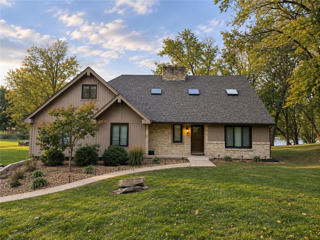 Walls of windows, sweeping lake views, and spaces designed to bring everyone together, welcome to lakefront living at Weatherby Lake! This carefully maintained 1.5-story home combines the character of its original construction with a spacious, versatile floor plan designed for everyday living and entertaining.With 4 bedrooms and 5 bathrooms, the layout offers exceptional flexibility. The main level features a primary suite plus a second bedroom and full bathroom, while upstairs, two generously sized bedrooms each enjoy private en suites. The expansive finished walkout lower level provides three distinct gathering areas, offering endless possibilities for entertaining, recreation, or relaxing.Walls of windows along the back of the home fill the breakfast area and great room with natural light while showcasing beautiful lake views. The expansive east-facing deck offers multiple spaces to enjoy morning coffee, spectacular sunrises, and outdoor entertaining. Below, the large, level backyard provides plenty of room for gardening, playing, or gathering with friends and family. A new roof and new concrete dock add to the home's appeal, with sweeping views south along the main channel from the dock.The private dock provides direct access to boating, swimming, fishing, sailing, and paddle-boarding right from your backyard. Weatherby Lake residents enjoy full lake privileges, city parks, tennis and pickleball courts, trails, active community groups, and year-round events. All just minutes from NW Barry Road, shopping, dining, Parkville, downtown Kansas City, Johnson County, KCI Airport, and major highways.A special opportunity to enjoy generous living spaces, beautiful lake views, and a suburban lake lifestyle. Welcome home to Weatherby Lake!