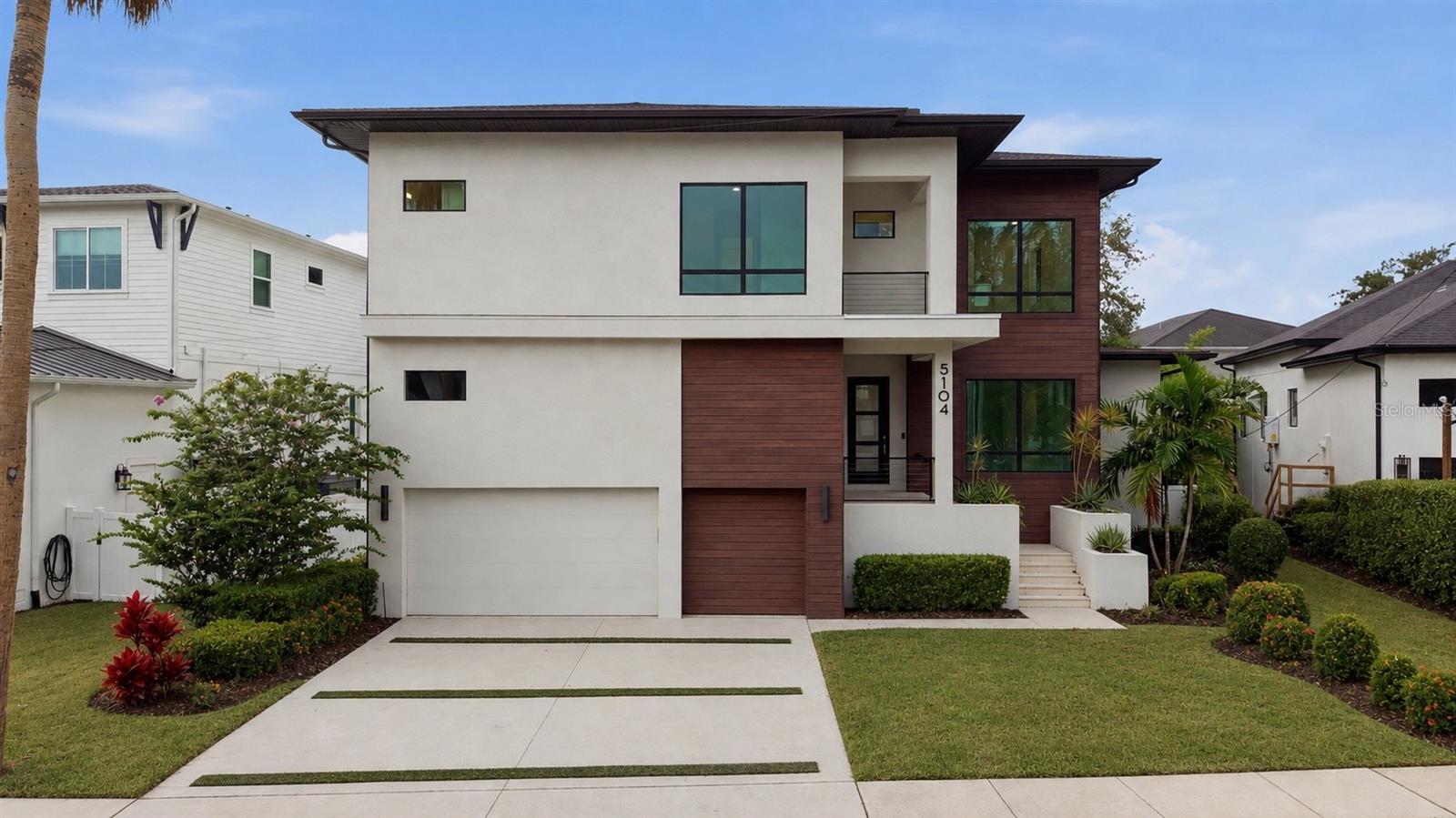 Virtually Staged. Welcome to an exceptional custom residence in the heart of South Tampa’s prestigious Beach Park neighborhood. Offering 4,820 square feet of thoughtfully designed living space, this contemporary home seamlessly blends sophisticated architecture, elevated finishes, and effortless functionality for modern luxury living.From the moment you enter, soaring 10-foot ceilings, wide-plank wood flooring, smooth-finish walls, and expansive hurricane-impact windows create a bright, refined atmosphere. The open-concept main level is designed for both everyday living and effortless entertaining, featuring a private study with a hidden closet and nearby full bath, along with a striking glass-enclosed wine room illuminated with custom LED lighting.At the heart of the home, the chef’s kitchen delivers both beauty and performance with premium Wolf and Sub-Zero appliances, quartz countertops, a spacious butler’s pantry, wine refrigerator, and generous prep and entertaining space. The kitchen flows seamlessly into the dining and great room areas, creating an inviting setting for gatherings of any size.Expansive sliding doors extend the living space outdoors to a private resort-style retreat featuring a sparkling pool with a new pool pump, expansive travertine-paved lanai, summer kitchen, and outdoor shower, creating the perfect setting for year-round Florida living and entertaining.A spacious first-floor guest suite with a private en-suite bath offers comfort and privacy for family and visitors. Upstairs, the luxurious owner’s retreat provides a serene escape, complete with a custom walk-in closet and spa-inspired bath featuring a dramatic wet room, contemporary soaking tub, dual vanities, and dedicated makeup area.Three additional upstairs bedrooms each feature private en-suite baths and walk-in closets, while the expansive bonus room offers exceptional flexibility as a media room, game room, lounge, fitness space, or additional retreat.Additional features further enhance the home’s functionality, including a mudroom, epoxy-coated three-car garage, a large storage area above the garage, tankless water heater, EV charger, and two Trane HVAC systems.Located in one of South Tampa’s most sought-after neighborhoods, 5104 W Evelyn Drive offers a rare combination of contemporary design, exceptional craftsmanship, resort-style outdoor living, abundant storage, and sophisticated everyday comfort. More than a beautiful home, it is an exceptional opportunity to experience the best of the South Tampa lifestyle.
