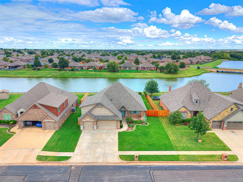 Nestled in a quiet, gated neighborhood within the highly sought-after Deer Creek Schools district, this waterfront home offers the perfect blend of privacy and convenience. Ideally located close to the highway, the property sits on a peaceful cul-de-sac with catch-and-release fishing right in your backyard, showcasing stunning lake views.

Enjoy relaxing evenings on spacious front porch complete with a charming porch swing. The upgraded kitchen is a chef’s dream, featuring an expansive quartz island, backsplash, and abundant storage. The master suite boasts a tray ceiling and a luxurious bathroom with dual vanities, a walk-in shower with three showerheads, a jetted tub, and direct access to an enormous walk-in closet.

Upstairs, a versatile bonus room is perfect for entertainment and includes a half bath, wired speakers, and a recently expanded attic with convenient walk-out access. This home truly offers something for everyone!