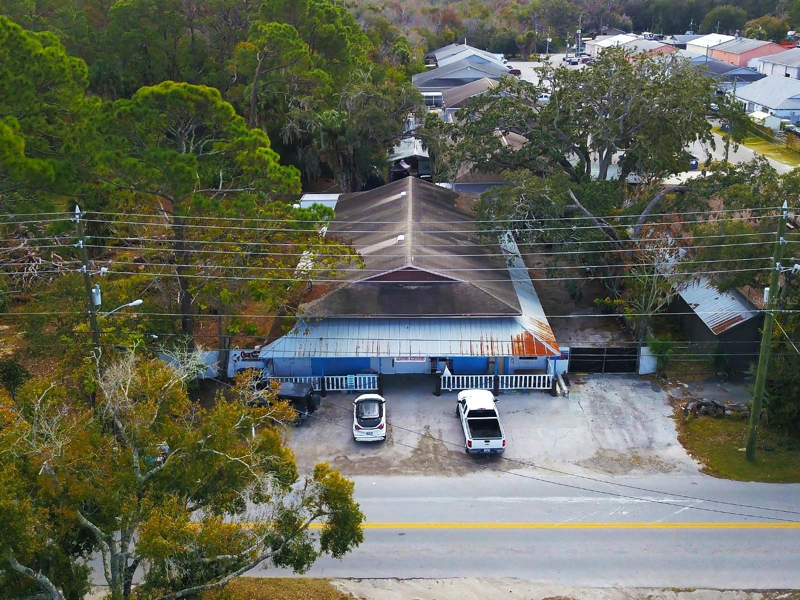 Commercial warehouse. Zoned C3. 5,512 sq ft of heated space. Built in 1988 on slab. NEW 2025 AC, mini splits. Pine Hill Road retail frontage, enabling high-visibility customer interaction. Operationally, the property features five ground level 12ft by 16ft roll-up bay doors. Male and female restrooms. The second floor includes two offices, a conference room and storage room. One water heater from 2020. A freshwater well. 120ft of fence from the front to the back of the property. Parking spaces for both customers and employees.