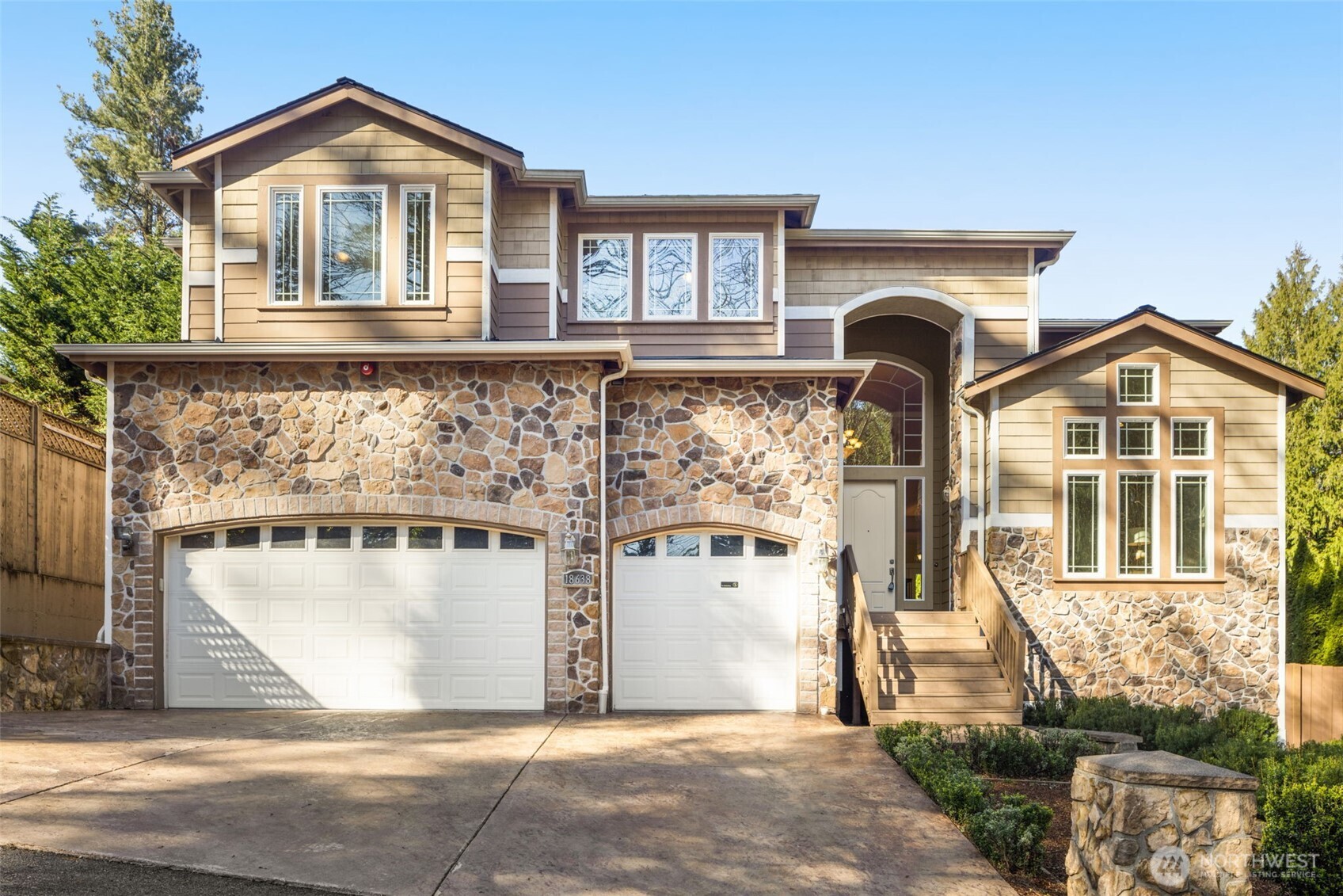 Nestled in a private setting just minutes from downtown Bothell, this high-quality custom home showcases exceptional craftsmanship and timeless design. A grand entry welcomes you with an elegant curved staircase featuring open metal balusters, setting the tone for the refined interiors throughout. The formal living room impresses with soaring ceilings, a gas fireplace, and walls of windows that fill the space with natural light. The chef’s kitchen is beautifully appointed with rich cherry cabinetry, slab granite countertops, and a large island with bar seating. The spacious family room offers a second gas fireplace. Step outside to enjoy the covered patio and deck off the dining room. Upstairs, the luxurious primary suite features a spa-inspired 5-piece bath, a generous walk-in closet, and a sitting area. A guest en-suite and a 3rd bedroom each with walk-in closet. A versatile loft and full hallway bath complete the upper level. Additional highlights include a main-floor office, gleaming hardwood floors on the main, art niches, skylights, wainscoting, built-in cabinetry, stunning stonework, and extensive millwork throughout. Spacious 3-car garage and pre-plumbed for A/C. Sought-after Northshore School District. Conveniently located just steps from Bothell High School and moments from the shops, dining, and amenities of downtown Bothell, with easy access to the Eastside and downtown Seattle.
