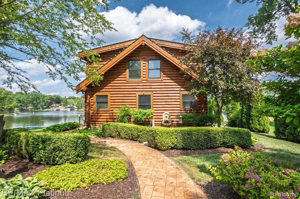 Welcome to this stunning Heritage Log home with 79 feet of lake frontage on all-sports Woodland Lake. Set on a rare and deep 478-foot lot, this home is filled with charm, warmth, and functionality. Featuring 2 bedrooms and 2.1 bathrooms, it also includes a fully finished basement with a custom wine cellar and a spacious cedar closet. Natural wood details and custom finishes throughout create a cozy yet refined retreat, ideal for year-round living or peaceful getaways.   It’s also the perfect legacy property—an ideal setting to build lasting memories for generations to come.

Two impressive 1,000 sq ft garages provide exceptional versatility. The primary garage is paneled and can serve as an additional entertaining space on rainy lake days, while the second garage offers ample room for storage and recreational needs.

Located just minutes from expressways and downtown Brighton, this home offers a rare combination of privacy and convenience. Whether you're seeking a full-time residence, seasonal escape, or investment opportunity, this distinctive lakefront property is a standout on highly desirable Woodland Lake.

BATVAI
