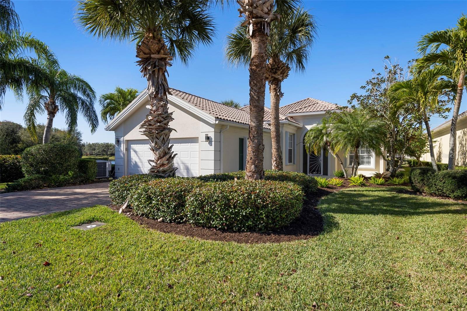 Move-In Ready Waterfront Home with Over $125,000 in Upgrades Available Now! Why wait to renovate when you can move right into this beautifully upgraded three-bedroom plus den Oakmont model in the highly sought-after, gated community of VillageWalk? Perfectly positioned on a quiet cul-de-sac with peaceful water views on two sides, this home offers the comfort, quality, and convenience buyers are looking for today. With more than $125,000 in thoughtful improvements already completed, you'll enjoy immediate peace of mind and years of worry-free living. The remodeled 2020 kitchen features quartz countertops, a tile backsplash, pull-out cabinetry, a closet pantry, and abundant storage, creating a stylish and functional space for everyday living and entertaining. Both bathrooms have been beautifully updated with quartz countertops and modern showers, while newer flooring and fresh interior paint provide a clean, contemporary feel throughout. Step outside to the covered lanai with ClearVue screening and electronic shutters, where tranquil water views create the perfect setting for morning coffee or evening relaxation. Built by Divosta using poured reinforced concrete construction and equipped with accordion hurricane shutters, this home offers the durability and protection Florida buyers value. Additional features include a central vacuum system, custom built-in shelving in the den, attic storage, upgraded landscaping, newer water heater, 2025 washer and dryer, EV charger in the garage, extra deeded driveway space, and a garage refrigerator that conveys. VillageWalk is a 24-hour gated, resort-style community offering an exceptional lifestyle with lush landscaping, scenic lakes, and miles of walking and biking paths. Residents enjoy a geothermal heated resort pool and lap pool, six Har-Tru tennis courts, pickleball, basketball, bocce, a state-of-the-art fitness center, restaurant and bar, Tiki Bar, boutique, gas station, and a full calendar of social activities. Located just minutes from Siesta Key Beach, Legacy Trail, Costco, shopping, dining, and top medical facilities, this home combines an outstanding location with exceptional value. Homes that are fully updated and ready for immediate occupancy are in high demand. Skip the projects, avoid the renovation costs, and start enjoying the Sarasota lifestyle from day one.