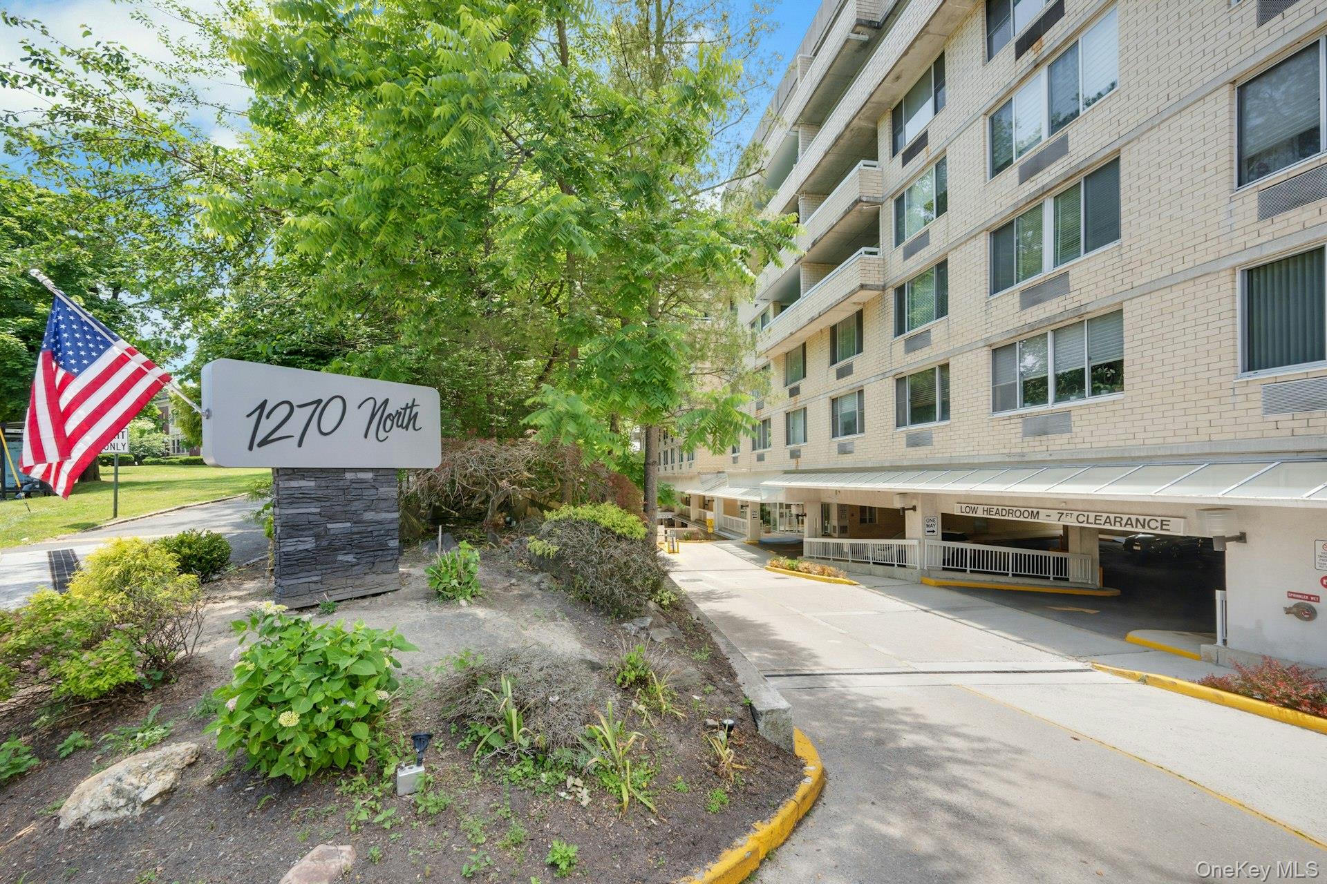 Step into effortless, turnkey living in this beautifully renovated 2-bedroom, 2-bath residence located in a full-service condominium with 24-hour concierge service in the highly sought-after Wykagyl neighborhood of New Rochelle. Thoughtfully redesigned from top to bottom, this sophisticated home showcases exceptional craftsmanship and premium finishes throughout. Wide-plank white oak flooring flows seamlessly through the open-concept layout, creating a warm and contemporary ambiance. The stunning chef's kitchen serves as the heart of the home, featuring quartz countertops, custom cabinetry, and high-end Thermador appliances, all seamlessly connected to the spacious living and dining areas, perfect for both everyday living and entertaining. Positioned on the quiet side of the building, the residence enjoys peaceful exposures away from North Avenue and the nearby shopping center. The well-designed floor plan offers privacy and functionality, with both bedrooms situated off a separate hallway. The primary suite is a true retreat, complete with custom walk-in closet and a beautifully expanded spa-inspired en-suite bath appointed with elegant Kohler fixtures and designer finishes. A second fully renovated bath, also featuring Kohler fixtures, serves guests and the additional bedroom with equal style and sophistication. This exceptional offering includes two deeded indoor garage parking spaces, along with ample covered guest parking. Residents enjoy an impressive array of amenities including a 24-hour concierge, outdoor pool and patio, fitness center, sauna, card room, and laundry facilities on every floor. Ideally located just moments from shopping, dining, banking, the post office, CVS, and the prestigious Wykagyl Country Club, this home perfectly blends modern luxury, convenience, and low-maintenance living. A rare opportunity to own a truly move-in-ready residence in one of New Rochelle's most desirable communities.