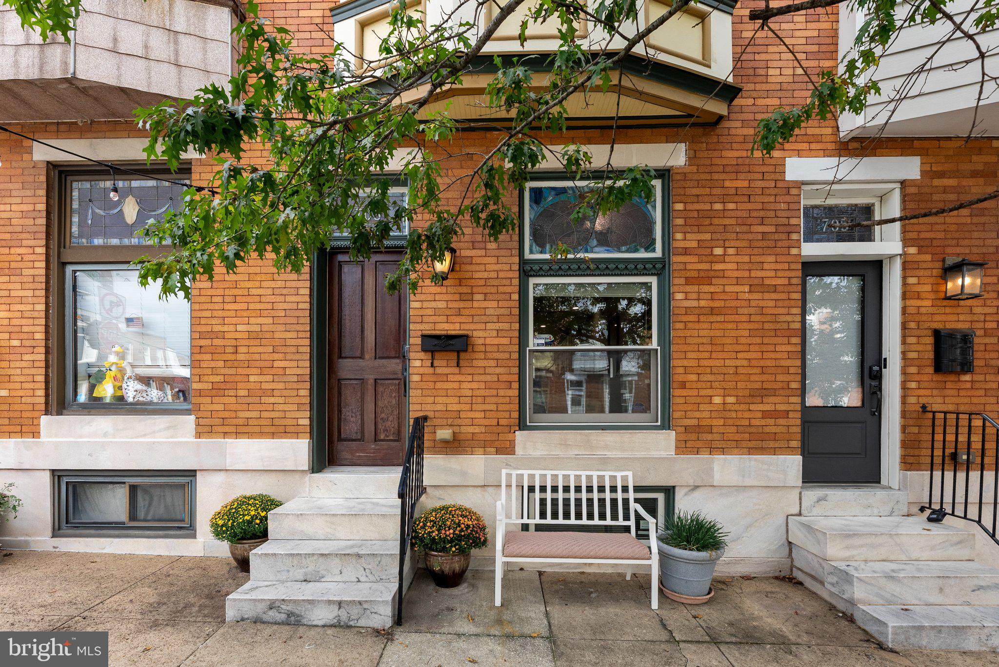 Welcome to 703 S Linwood Avenue in desirable Canton! This beautifully maintained Federal-style brick row-home delivers just under two thousand square feet of finished living space across three levels, with three bedrooms, three full baths, private one car carport, street parking and adjacent to Patterson Park parking and outstanding outdoor living.The main level features a spacious living room with a white-painted brick accent wall, hardwood floors and recessed lighting, flowing directly into the dining area and upgraded kitchen. The kitchen is the centerpiece, offering granite countertops, a large center island, breakfast bar, gas cooking, abundant cabinetry, recessed lighting, and a convenient eat-in area. A brand new GE built-in microwave was just recently installed. The open layout makes everyday living and entertaining easy, while classic details add character throughout.Upstairs, the spacious primary bedroom features a beautiful bay window giving an abundance of natural light, as well as hardwood flooring, recessed lighting, and a private en-suite bath with ceramic tile and tub/shower. A second generously sized bedroom with hardwood floors and recessed lighting shares hallway access to another full bath with stall shower.The fully finished lower level adds valuable flexibility with a third bedroom, full bath, recreation room, built-ins, laundry, and walkout stairs access. Use the additional space as a guest suite, home office, gym, media room, or comfortable second living area.Take the entertaining outside to the deck or head up to the roof deck for panoramic city views. Whether you're enjoying your morning coffee, hosting friends for a perfect view of fireworks, taking in the Baltimore skyline, enjoying the Blue Angels flying overhead, the outdoor spaces add another dimension of recreation and lifestyle to this exceptional city home.Located in the heart of Canton, about a 100 yards from Patterson Park, you're close to neighborhood restaurants, shops, entertainment, waterfront destinations, and major commuter routes. With classic brick architecture, modern conveniences, three finished levels, a gourmet-style kitchen, finished lower level, roof deck, city views, and private parking, this home checks all the boxes for a comfortable Baltimore City lifestyle.TWILIGHT OPEN HOUSE THURSDAY 9/24 5-7pm drinks and snacks