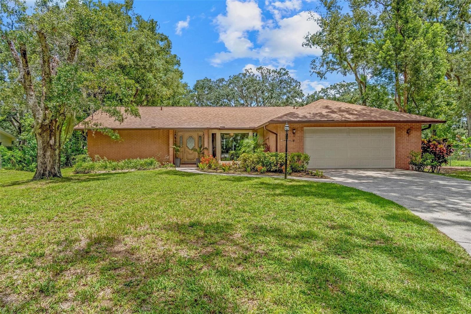 Endless possibilities await in this beautifully maintained 3-bedroom, 2-bath pool home with a 2-car garage, perfectly situated on an oversized lot!  Step into the welcoming foyer and be immediately drawn in by the bright, open layout filled with natural light. The spacious living and dining areas flow seamlessly into a large kitchen and a cozy family room featuring a charming fireplace—ideal for hosting gatherings or enjoying quiet nights in.  Each of the three bedrooms is generously sized, offering plenty of comfort and flexibility. The primary suite includes a walk-in closet and a private ensuite bath for your own peaceful retreat.  Outside, your private oasis awaits—a stunning screened-in lanai opens up to an in-ground pool, perfect for relaxing or entertaining all year round. The expansive backyard also includes storage sheds for all your tools, toys, or hobbies.  Unbeatable combination of space, functionality, and outdoor living, this is the dream home you’ve been searching for!