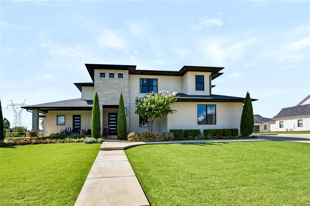 Welcome to this custom-built home in the gated Summit Lake Estates community, located in the highly sought-after Deer Creek School District. Built in 2020 and situated on .89 acres, this 3,652 sq ft home offers 5 bedrooms, 3 full baths, 2 half baths and a 4-car garage with a thoughtfully designed layout made for everyday living and entertaining.The main living space overlooks the backyard retreat featuring a pool, hot tub with rock waterfall, outdoor kitchen and covered living space. Large sliding doors create an easy transition from indoors to out, while a convenient pool-access half bath makes entertaining even easier. The kitchen is a standout with a waterfall island, Sub-Zero refrigerator, 48" Fisher & Paykel gas range with griddle, Fisher & Paykel dishwasher and black porcelain sink.The oversized primary suite offers private access to the outdoor living area, a coffee bar, spacious bath with freestanding tub and walk-in shower, and an impressive double closet with convenient access to the utility room. A private office, mud bench and soaring entry complete the main level.Upstairs you'll find four generously sized bedrooms with walk-in closets, two full baths, an additional laundry closet and a spacious bonus room with refrigerator, sink, storage and half bath. The bonus room opens to a balcony overlooking the pool and backyard.Additional features include a 4-car garage, storm shelter, tankless hot water and sprinkler system. Enjoy nearly an acre in a gated community known for its peaceful setting, multiple fishing ponds and quiet evenings. To make this home even sweeter, qualified buyers who finance with Lisa Buck Harwi at Great Plains Bank may receive a 1% lender credit toward eligible closing costs or a rate buy-down, subject to lender approval and program terms.