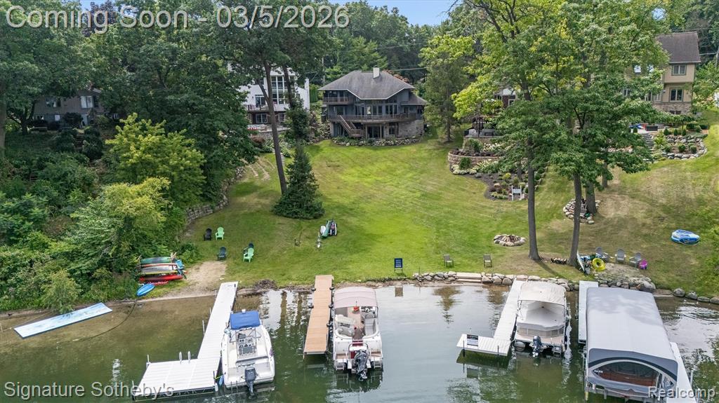 Experience the perfect blend of luxury, comfort, and breathtaking views in this stunning custom lakefront home, nestled in a peaceful no-wake bay on the crystal-clear waters of White Lake—one of Oakland County’s most beautiful all-sports lakes. Set on a quiet street and surrounded by mature trees and lush landscaping, this property offers exceptional privacy and year-round enjoyment. The expansive open floor plan is filled with natural light from walls of windows that showcase water views from nearly every room. The elegant master suite features an updated bathroom and a private covered balcony—ideal for enjoying your morning coffee while taking in the serene lake scenery. The chef’s kitchen is outfitted with granite countertops, a Sub-Zero refrigerator, and premium stainless steel appliances. The finished walk-out lower level adds even more living and entertaining space, complete with a wet bar and direct access to the patio. A heated driveway ensures winter convenience, eliminating the worry of snow or ice. This exceptional home combines thoughtful design, high-end finishes, and a premier waterfront setting—truly a rare find.