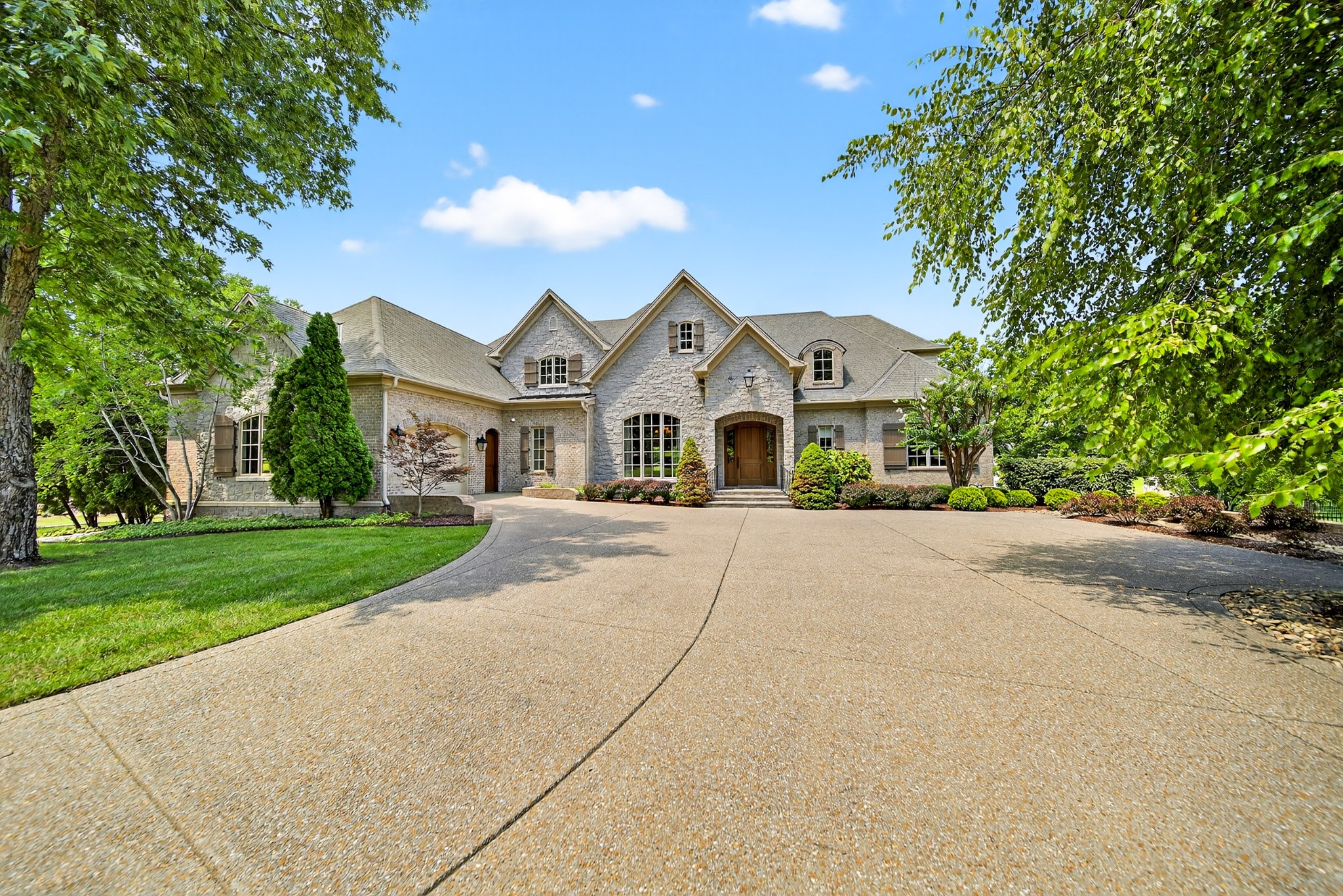 Be prepared to be amazed by this 10,525 sq ft lakefront estate, 6 bedrooms, 5 full baths and 2 1/2 baths on 1.5 private acres. Masterfully built by Hughes Edwards Builders. Home was featured in Charity Tour of Homes. This one-owner, custom-built home offers a lifestyle of elegance, function, and relaxation on the peaceful shores of Old Hickory Lake. Complete with private boat dock equipped with electricity and water. This home features 2 full Kitchens, 8 Living/Flex/Bonus Spaces. Primary bedroom suite open to Lanai, 2nd large bedroom on Main level w/bath, 20x13 Craft Room, 2 bedrooms w/baths on 2nd Level, Elevator, Main Level Office with Bookcases and spiral staircase. Lower Level features Living room w/fireplace, full kitchen, utility room, 2 bedrooms. Amenities include high-end appliances, luxury finishes, multi-generational spaces,whole house sprinkler system, concrete-reinforced storm shelter and whole house generator. This home is a rare combination of size, function, beauty, and waterfront serenity. Whether you're hosting a crowd, working from home, accommodating extended family, or simply enjoying lake life in comfort and style this is a truly extrodinary home. Convenient to Shopping and Restaurants. ***Amenity Feature Page attached in documents***Floorplan attached in documents***