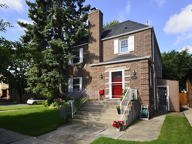 Check out this stunning 5-bedroom brick home situated on a sunny corner lot in a prime West Ridge location! A perfect fusion of traditional elegance and modern comfort, this property offers large living spaces throughout complemented by a great layout, and lush outdoor areas with maintenance free living. Enjoy the abundant sunlight streaming through large beveled windows filling every corner with brightness. 1st floor has a fantastic floor plan, w oversized livingroom, Beautiful BEVELED glass windows to bring in amazing light, large formal dining room, perfect for large family entertaining. A CHEF's kitchen w STAINLESS appliances &  GRANITE counter tops, abundant cabinetry with ROLL-OUT LOWER shelves, tray cabinet, glass door cabinet, 2 PANTRIES, one with LAZY SUSAN,additional corner lazy susan, sizable BREAKFASTBAR for sitting or your sous chef to chop veggies, with plenty prep space to prepare gourmet meals! Breakfast room w SKYLIGHT  for informal dining w room for stools. BONUS 1st FLOOR DEN/OFFICE is super convenient for WORK-AT-HOME, homework space, with room for 2 desks, The first floor level is perfect for entertaining! Just open your BEVELED Sliding glass door off breakfast room/kitchen onto the HUGE DECK, leading to the LUSH Green BACKYARD! Much valued 1/2 BATH on the MAIN LEVEL. Upstairs a KING-SIZED PRIMARY bedroom, shared FULL BATH.  It's great to have 4 BEDROOMS ON THE SAME LEVEL, especially if you may have kids. Full FINISHED basement/FAMILY ROOM w 5th BEDROOM (perfect guest room, teen room, office, etc)  and another FULL BATH. Huge DECK is great for outdoor parties (I can almost smell those steaks cooking, can't you?), bonus patio area near garage is great if you have an RV, Boat, or additional car, grapevines, PERGOLA, FENCED YARD w landscaped garden. There is a FLOOD CONTROL SYSTEM to keep water out, and a SPRINKLER SYSTEM to keep your grass and garden watered making it almost maintenance free. Beautiful perrineals, lilac trees, rose of sharon shrubs, mature trees and more. FENCED DOG RUN. Tear-off ROOF 2021, BOILER 2023, hot water 2023 and central air conditioning.  Side 2 CAR GARAGE with DRIVEWAY is super convenient and allows for 2 EXTRA CARS. Enjoy this quiet block of single family homes, across from the Mosaic Arts school (previously Boone). Situated in a great location, this home is close to parks, walking areas, and public transportation, ensuring convenience at every turn. Close to many homes of worship, tons of delicious restauraunts and shops, grocery stores on Devon, Aldi's, Walk to Indian Boundry Nature Park and Warren Park. With its thoughtful design, abundant light, and flexible layout, this home is more than just a place to live, it's a space where you can truly thrive. ......THERE IS SO MUCH MORE THAT DOES NOT FIT IN THIS LIMITED SPACE. ADDITIONAL FEATURES, BENEITS AND DETAILS ARE IN THE LISTING DROPDOWN. MAKE SURE YOU READ! IT IS EASIER THAN TRYING TO READ THIS SMALL PRINT. I CAN'T WAIT TO SHOW YOU THIS H-U-G-E Home.