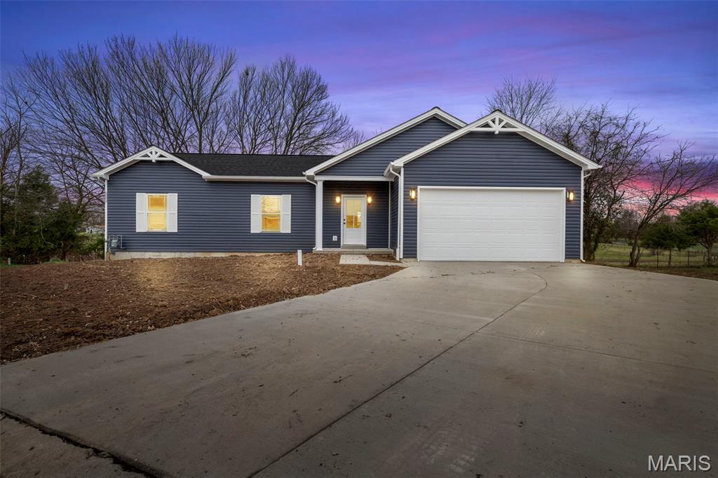 Discover this beautifully crafted new construction ranch home featuring 3 bedrooms & 2 baths in Jonesburg, Missouri. This brand-new 1,425-square-foot residence is set on a quiet cul-de-sac and features a spacious open layout that blends comfort, style, and modern amenities. As you step inside, you'll notice the spacious living room, where the open floor plan immediately creates a sense of space and connection and flows seamlessly into the breakfast room, making it an ideal setting for everyday living. Just beyond, the kitchen showcases 42-inch soft close cabinets with crown molding, beautiful white Quartz countertops, a pantry, and stainless steel appliances including an electric range, microwave, and dishwasher. With 9-foot ceilings and LED lighting throughout, the main living area feels bright, open, and welcoming. Down the hall, you’ll find three well-designed bedrooms, each equipped with a ceiling fan. The deluxe primary suite features a beautifully finished bathroom with a separate shower with door and a double vanity. The second full bathroom also includes a double vanity, offering excellent convenience. Laminate flooring runs throughout the main living spaces, and the main-floor laundry room includes wired shelving for added function. The extra-wide driveway and fully finished and insulated two-car garage provides extra outlets, keypad entry and two remotes for the garage door opener adds everyday convenience. The basement includes an egress window, a rough-in for a future bathroom, and a sump pump, giving you great potential for additional finished space. A 12’ x 10’ deck has just recently been competed, photos to come. The home is equipped with a reliable Lennox heating and cooling system, as well as a 2-10 Home Warranty will be included for peace of mind. Features a level, oversized lot.  The front and back property will be aqua seeded to complete the exterior leaving nothing for you to do but move in and make it your own.