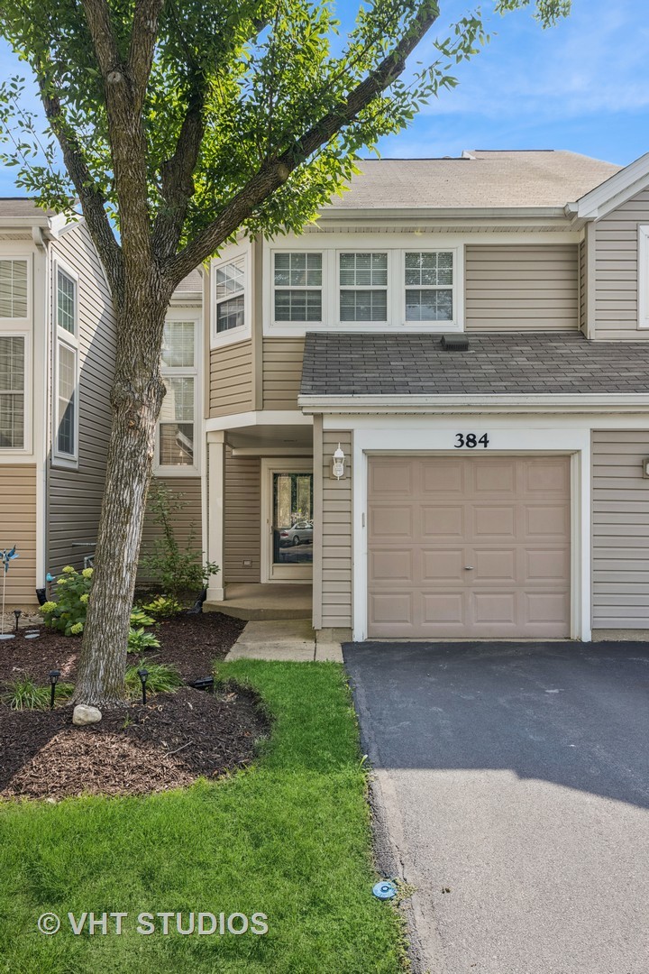 Welcome to this sun-drenched townhome tucked away on a quiet cul-de-sac in the sought-after Steeplechase community of Carol Stream. Step inside to discover soaring two-story ceilings in the living and dining rooms, filling the space with abundant natural light and an airy, open feel. The cozy fireplace is perfect when entertaining or on a cool winter evening. The refreshed kitchen is adorable featuring classic white cabinetry, brand-new quartz countertops, and sleek stainless steel appliances. Both bathrooms have been tastefully updated, and new carpeting adds a fresh touch throughout. Upstairs, you'll find hardwood floors in the bedrooms offering both style and durability.  Enjoy the outdoors with your own private patio surrounded by lush green space-perfect for relaxing or entertaining. This home also offers an attached one-car garage and provides ample guest parking.  Ideally located near major thoroughfares and shopping, and just a short walk to Cloverdale Elementary School and Hampe Park, this home combines comfort, convenience, and charm.    Don't miss your opportunity to own this beautifully updated home in a prime location!