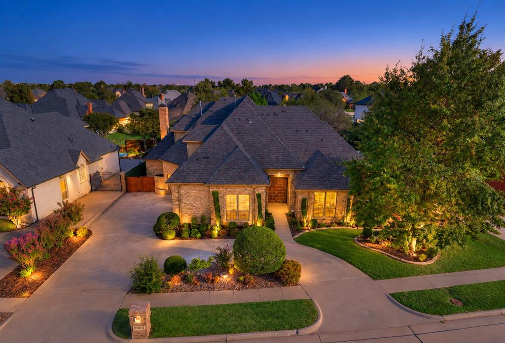 Distinctive custom architecture and exceptional functionality come together in this one-of-a-kind home! Situated on a lushly landscaped lot in the desirable and established Brookhaven. An especially valuable and uncommon feature is the discreetly integrated elevator for easy access to the second floor! The primary suite is located on the lower level. There is a versatile study or possible bedroom with floor to ceiling bookshelves also on the lower level with 1/2 bath access.  The living space is abundant with versatile spaces to use as dining or living, a casual dining, plus the great room off the kitchen, ALL offering large window views of the beautifully landscaped backyard! The great room boasts floor to ceiling richly stained built-in shelving and a brick fireplace. The kitchen is a cooks dream and offers it all including a gas cooktop island, large pantry, bar seating, and even a desk! The upstairs offers a bedrooms, each with bathroom access. An oversized 3 car garage is a great feature and is where the lower level elevator access is tucked away in a closet! Don't miss out on this truly unique home offering enduring style, generous living spaces and all the comforts desired in a convenient West Norman location.