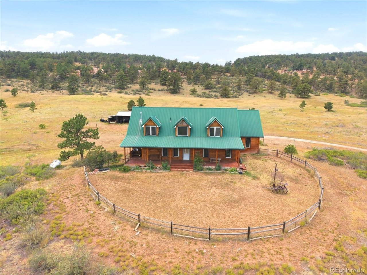 Escape to 38.5 acres of Colorado countryside just moments from Carter Lake, where wide-open space, privacy and endless possibilities come together. Set among rolling acreage with its own picturesque kettle pond, this unique Berthoud property offers a rare opportunity to enjoy a true rural lifestyle while remaining within reach of Northern Colorado amenities. The log home is full of character, with warm wood finishes, a stone fireplace, expansive windows and inviting outdoor spaces that take advantage of the peaceful setting. With approximately 3,390 finished square feet, the home offers 3 bedrooms, multiple living areas and a finished walkout basement with a newly added 3/4 bath, providing flexibility for recreation, guests or a home gym. The flexible layout also creates opportunities for multigenerational living, with separate areas for both connection and privacy under one roof. Above the attached garage, a separate study, office or loft-style bonus space creates an ideal retreat for working from home, hobbies or additional flex space. Outside is where this property truly sets itself apart. Nearly 40 acres provide room to spread out, explore and make the land your own. A substantial detached outbuilding offers an enclosed workshop/garage bay along with additional covered equipment and storage space. Whether your vision includes horses, livestock, dirt bikes, a workshop, outdoor recreation or simply room between you and your neighbors, this property gives you space to create the lifestyle you've been looking for. And for those who love the water, Carter Lake is practically in your backyard, putting boating, fishing, camping, hiking and miles of Colorado recreation within easy reach. Private, versatile and surrounded by the natural beauty of Northern Colorado, this is more than a home; it's an opportunity to own acreage, embrace the outdoors & create something entirely your own. **PER THE COUNTY, AN ADU/ALA CAN BE BUILT; CONTACT THE LISTING AGENT FOR DETAILS**