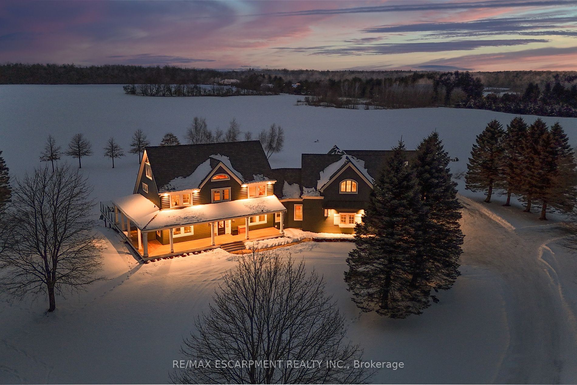 Luxury, comfort & country living! 91.6-acre estate offers rolling farmland, dense woodlands & tranquil pond. Fully renovated 2.5-storey, 6 bed, 6 bath home w/ attached 2 bed 2 bath guest house was upgraded by Neven Custom Homes in 2022/23, featuring $2M in premium finishes. DaVinci composite shake roof, custom windows, new doors, spacious living areas & elegant details throughout. Grand wrap-around veranda & glass-railed deck. Gourmet kitchen w/ 2 expansive islands, ample storage & top-tier appliances. Separate prep kitchen. Open-concept design leads to dining room, breakfast area & grand great room w/ 208 ceilings, stone fireplace & sliding doors to large deck. Main floor also includes powder room, laundry, mudroom, 3pc bath & 4-car garage. Upstairs, primary suite features timber frame accents & luxurious 5pc ensuite, while 2 additional bedrooms share a beautifully designed 4pc bath. Half-storey above offers bonus room, ideal for a studio or bedroom, along w/ a den. Lower level is perfect for extended family, w/ recroom, full kitchen, bedroom, bath & walkout to backyard. Attached guest house includes spacious kitchen, high-end appliances, separate laundry, walkout deck & open living/dining areas w/ panoramic views. Main-floor bedroom w/ walk-in closet & Jack-&-Jill ensuite. Additional features: 2010 outdoor tarp building, over 800 evergreen trees, forested area, 2 septic systems & 2 geothermal systems. Located near amenities, offers rare opportunity for luxurious lifestyle w/ endless possibilities. RSA