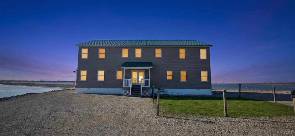 Rare opportunity to own a private waterfront retreat at the end of a peninsula overlooking Saginaw Bay and directly adjacent to the renowned Fish Point State Wildlife Area. This secluded setting offers panoramic water and wildlife views on three sides, delivering a true Northern Michigan lodge experience.  The home features 5 bedrooms and 5 bathrooms across approximately 3,200 square feet, designed to accommodate large groups, guests, or corporate retreats. A wrap-around porch captures stunning sunrise and sunset views, while expansive windows bring the outdoors in year-round.  Positioned along a major waterfowl flyway, this property offers exceptional opportunities for duck hunting observation and outdoor recreation, with thousands of birds visible during peak migration. The protected wildlife refuge to the southwest ensures long-term habitat preservation and uninterrupted natural scenery.  Additional features include a detached 2-car garage with upper storage, extended enclosed space for gear or equipment, ample parking for guests and trailers, and canal access with docking availability for boating and fishing on Saginaw Bay and Lake Huron.  Offered fully furnished and turnkey, including waterfowl d©cor and taxidermy, this property is ideally suited as a private residence, hunting lodge, or short-term rental investment.