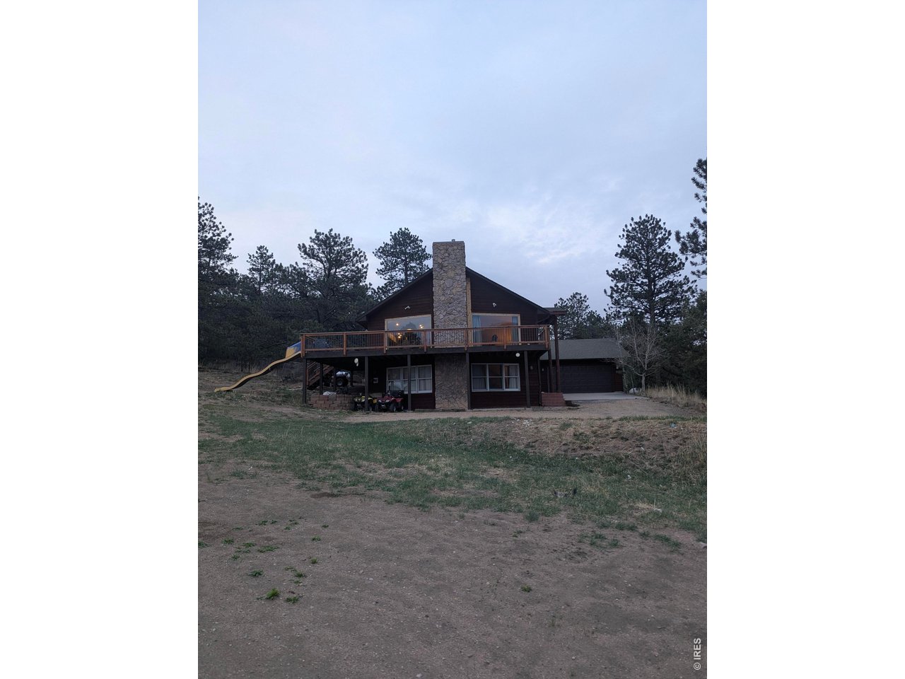 Kittle Real Estate presents a mountain retreat with space, views, and privacy! Set on 6.8 acres across 3 parcels in Pinewood Springs, this two-story home offers a peaceful setting surrounded by nature, where wide-open skies and foothill views become part of your everyday backdrop. The open main living area features large picture windows that flood the home with natural light while framing panoramic scenery, creating a bright and inviting space that feels connected to the outdoors. The kitchen is well-equipped for both daily use and longer stays in your mountain escape, featuring stainless steel appliances, granite countertops, and plenty of prep space and storage. Generously sized bedrooms provide space to relax and recharge, offering flexibility for how each room is used while maintaining a comfortable feel throughout. New paint and carpet make everything move-in ready. Outside, the wraparound deck gives you an incredible vantage point to take in foothill views, colorful sunsets, and even occasional wildlife, making it a standout feature for both quiet mornings and evening gatherings. An enclosed garden space surrounded by pine trees provides natural shade and creates a peaceful outdoor area to enjoy. The property is comprised of 3 parcels (1.8 ac, 0.9 ac, and 4.1 ac), giving you the option to add additional residences should you desire. Perfect for multi-generational families or someone looking to add a nearby rental. With access to acres of National Forest trails and the Little Thompson River with its private swimming holes, this property offers direct connection to outdoor recreation and nature. Plus, with just a short drive away to Lyons Estes Park, you get the feel of a secluded retreat while still being within reach of nearby towns, dining, and amenities. Stay tuned for professional photos!!