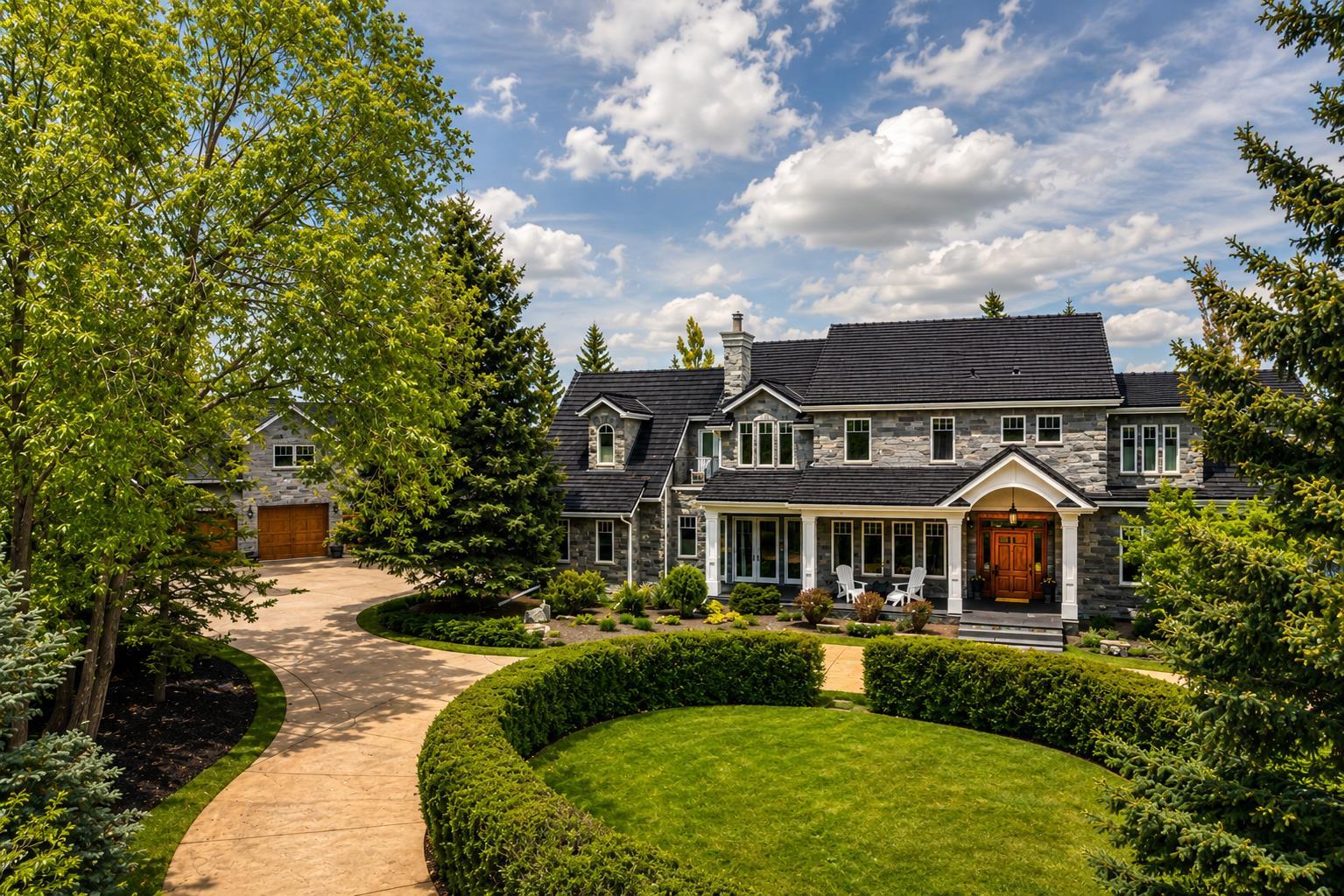 Situated in the prestigious enclave of Aspen Estates, this landmark Manor House Estate represents one of Calgary’s most significant residential offerings. Set on an extensively landscaped 36,155-square-foot lot within an exclusive cul-de-sac, the property offers a rare combination of scale, craftsmanship, privacy, and location. Constructed to an uncompromising commercial standard seldom seen in residential properties today, the residence was designed to evoke timeless old-world elegance while seamlessly incorporating modern luxury and convenience. Enveloped entirely in Ocean Pearl stone, the Estate home encompasses nearly 10,000 square feet of meticulously crafted living space across three levels, offering a level of quality and permanence that would be extraordinarily difficult to replicate today. The grounds are equally impressive, featuring extensive custom rockwork, a striking water feature centerpiece, mature trees creating an exceptionally private enclave, a grand front circular driveway, and a beautifully executed cobbled rear lane and patio designed to complement the Estate’s architectural character. Together, the landscaping and hardscaping create a setting that feels both stately and secluded. The residence features 5 luxurious bedrooms, 7 full bathrooms, 2 powder rooms, and over 1,200 square feet of outdoor patio space designed for grand-scale entertaining. A separate carriage house of more than 1,000 square feet sits above a remarkable two-level, 7-car garage, connected to the main residence by an enclosed galleria — ideally suited for a caregiver, extended family accommodation, private guest quarters, or a dedicated house manager’s residence. Distinguished interior appointments include site-finished wide plank Brazilian cherry flooring, extraordinary custom millwork throughout, warm cherry and oak finishing woodwork, top quality fixtures and fittings, handcrafted stained-glass accents, and a statement fireplace and coffered detailing anchoring the dramatic great room with soaring 18-foot ceilings. Additional features include a world-class gourmet kitchen, elegant vaulted drawing room, formal dining room with butler’s pantry, authentic Irish Pub-inspired bar, private media room, hot tub sunroom, and elevator servicing all levels. Located moments from Calgary’s most prestigious private schools and premiere west-side amenities, this extraordinary estate embodies legacy-calibre living — a residence defined by architectural significance, enduring materials, and exceptional long-term value in one of Calgary’s most coveted communities. A true address of distinction.