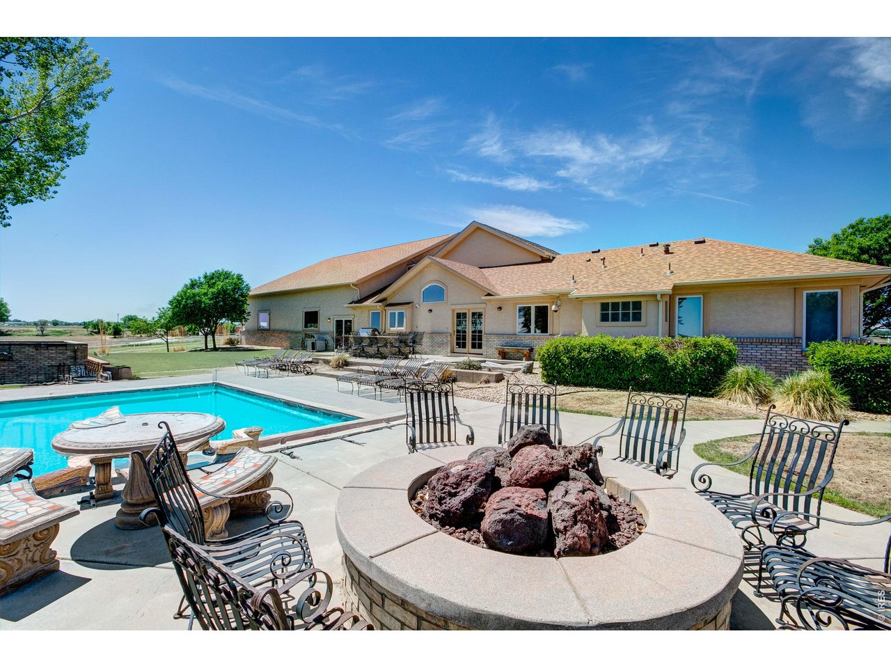 Priced below appraisal!! Set on 35 scenic acres w/breathtaking mountain views, this exceptional horse enthusiasts property offers the ultimate Colorado lifestyle with premium horse amenities & unmatched entertaining spaces. The custom 4-bedroom, 3-bath home features two spacious great rooms, including one with a built-in bar & speaker system designed for entertaining and gathering. Handmade custom cabinets & doors throughout home. Step outside to your private backyard oasis complete with a pool, in-ground hot tub, outdoor kitchen area, and gas firepit - all perfectly positioned to take in the surrounding views and Colorado sunsets. Designed for both functionality and lifestyle, the property is fully equipped with a 300x150 roping arena, announcer's stand, arena bar area, horse barn with attached 1-bedroom apartment, 11 pipe runs, turnout pastures with lean-tos, automatic waters throughout, and full perimeter pipe fencing. Additional improvements include an 80x40 heated shop and detached 2-car garage, offering ample space for equipment, trailers, hobbies, and storage. RV 30-amp hookup, sewer dump, 30 amp plug in at shop. With expansive open space, incredible views, and thoughtfully designed equestrian amenities throughout, this is a rare opportunity to own a true turn-key horse property. Looking for an additional business opportunity - don't count out the ability to Air BnB or turn into a beautiful wedding venue site!!