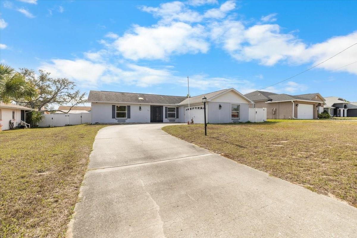 Diamond in the Rough - Priced to Sell! Unlock the potential of this 2-bedroom, 2-bath home offering endless possibilities for investors, renovators, or buyers ready to create their dream space. Featuring wood flooring, white PVC fencing, a screened lanai with vinyl windows and tile flooring, and a side-entry garage, this property is packed with character and opportunity. Major updates include a new A/C (2023) and updated windows and sliding glass door (2018), providing a strong foundation for future improvements. A detached 22x15 garage building with a garage door and side entry offers flexible use as a she-shed, man cave, workshop, or additional storage. An extra spacious storage shed adds even more functionality.This home does need TLC, but with so much potential and multiple outbuildings, the possibilities are endless. Priced to sell—don't miss this opportunity to add value and make it your own!