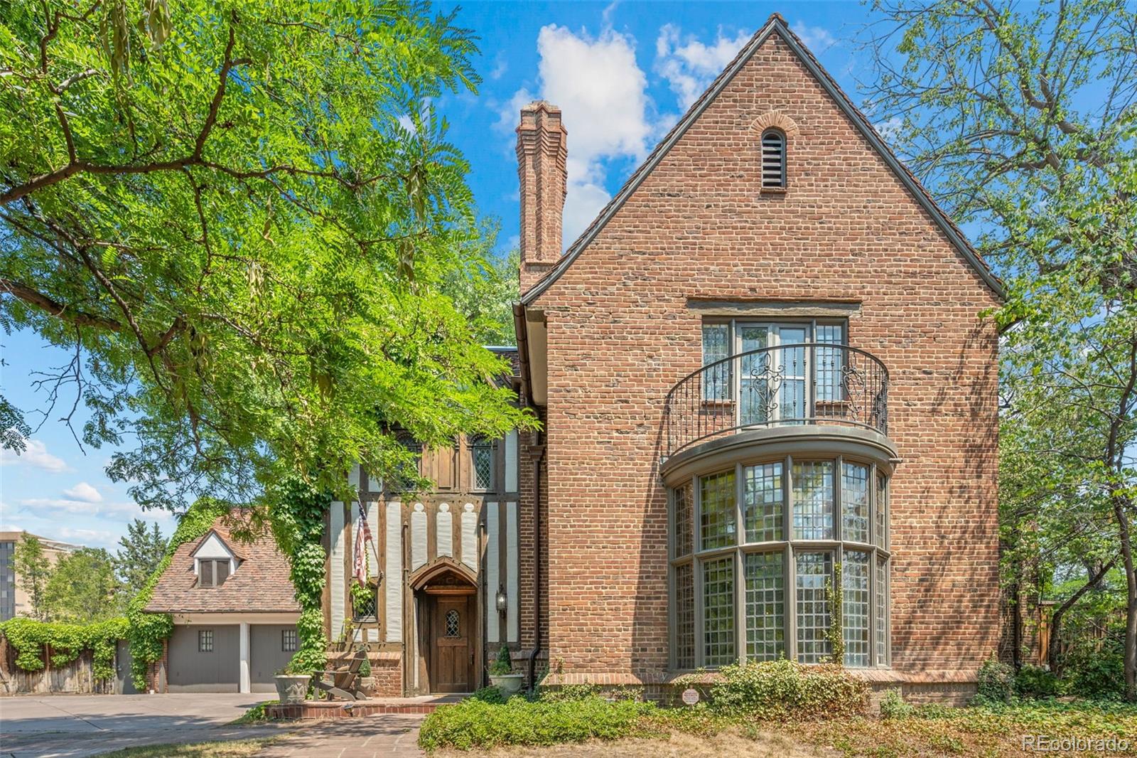Introducing the legendary Bromfield House, one of Denver's most significant historic residences & a true masterpiece in the prestigious Country Club neighborhood. Perfectly positioned on more than one-half acre overlooking Denver Country Club & Cherry Creek, this Tudor estate offers an extraordinary opportunity to own a piece of Denver's architectural legacy. Designed by acclaimed architect Burnham Hoyt for prominent real estate developer Donald Bromfield, this estate marked the beginning of Hoyt's celebrated career. After studying at the renowned Beaux-Arts Institute & earning national recognition for projects including Red Rocks Amphitheatre & The Broadmoor. Spanning nearly 10,000 square feet, the residence showcases an exceptional collection of preserved historic craftsmanship & timeless details. A dramatic two-story foyer welcomes you into elegant living spaces highlighted by the stunning coved floor-to-ceiling window in the formal living room, exquisite millwork, grand entertaining spaces, & countless original design that have been meticulously maintained for generations. The home features 7 spacious bedrooms, 9 bathrooms, former staff quarters in the lower level, & an attached three-car garage. One of the estate's unique features is its original attached greenhouse which is in need of some updating, but is ready for someone turn back into something exceptional. Equally charming is the detached playhouse/art studio, originally built for the Bromfield daughters. Recognized as a Denver landmark, the Bromfield House has been featured in numerous publications & stands as a defining example of early 20th-century residential architecture. Combining historical significance, unmatched craftsmanship, & one of Denver's most coveted locations, this is a once-in-a-generation opportunity. An offering of this caliber is exceptionally rare—where architectural excellence, rich history, & premier location come together in one unforgettable residence.