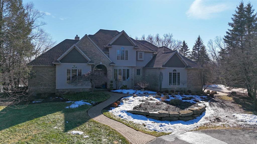 Tucked back 1,000 off the road for exceptional privacy, this impressive estate offers over 5,000 finished square feet with a beautiful pond view as your backdrop. The home welcomes you with striking curb appeal, a circular drive, and thoughtfully designed landscaping. Inside, enjoy soaring 20 ceilings in the living room, a dramatic fireplace focal point, and walls of windows that pour in natural light. Hardwood floors carry through the dining area and kitchen, where youll find abundant cabinetry, a large island, and a layout made for everyday living and entertaining. The main-floor primary suite features a private ensuite bath. The ease of living is continued with the convenience of main-floor laundry. Upstairs are three additional bedrooms-two connected by a Jack-and-Jill bath and a third with its own ensuite-offering flexible space for guests or a growing household. The walkout lower level is an entertainers dream with a full second kitchen, large recreation areas, and an additional bedroom with ensuite-ideal for multi-generational living or extended stays. Step outside to the patio and your in-ground pool, creating a resort-like setting for summer gatherings. A 3-car garage completes the package. This is a rare combination of space, privacy, and lifestyle-inside and out. Pond does not belong to this property. Property to be split. Home with sell with 8 acres Please be aware that there is recording/surveillance equipment on the property.